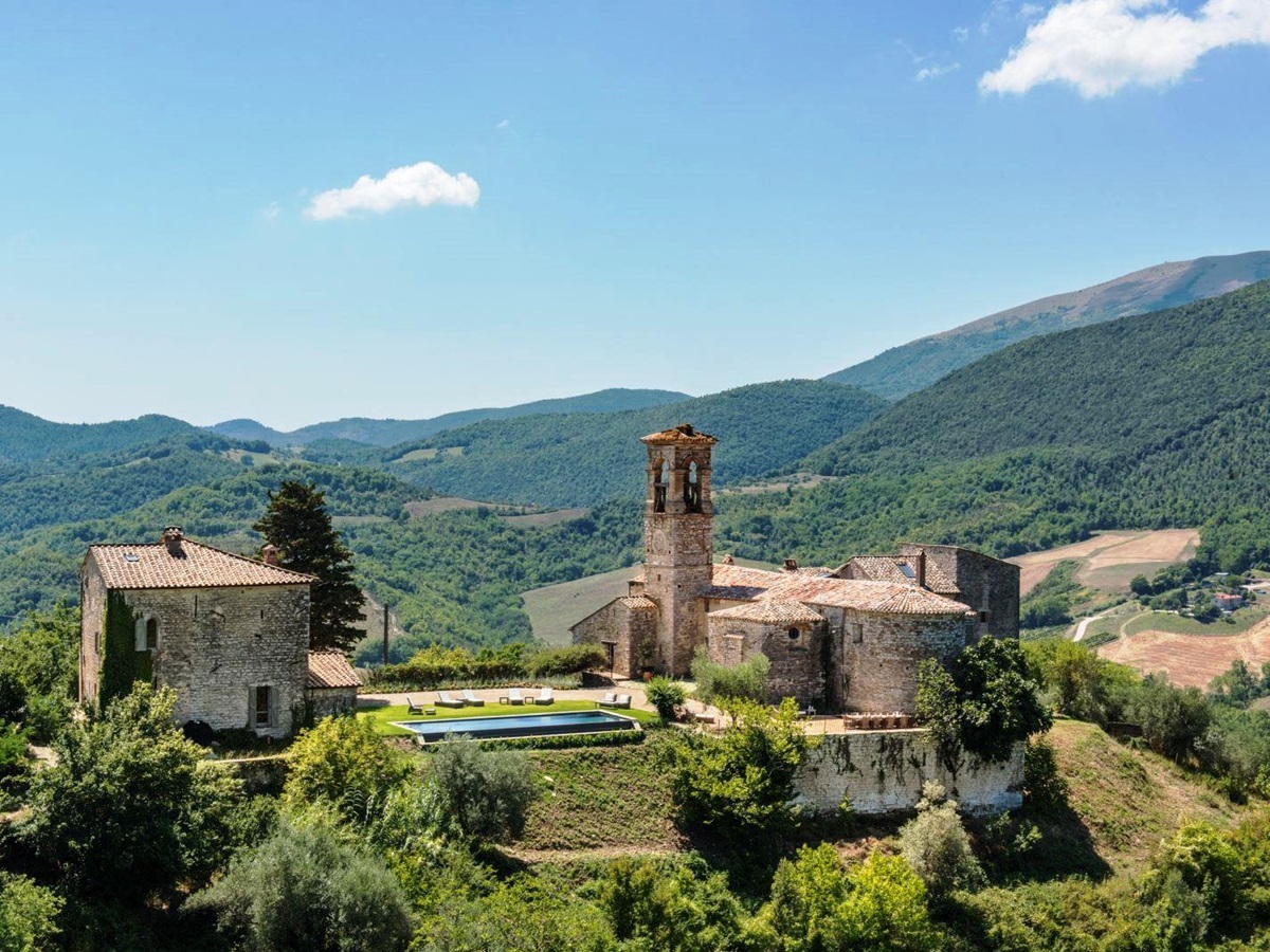 panoramic view of villa del conte in umbria, Italy with green wooded hills in the background