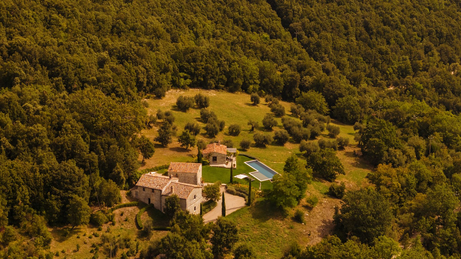 Drone view of Villa Piuma in Umbria surrounded by trees