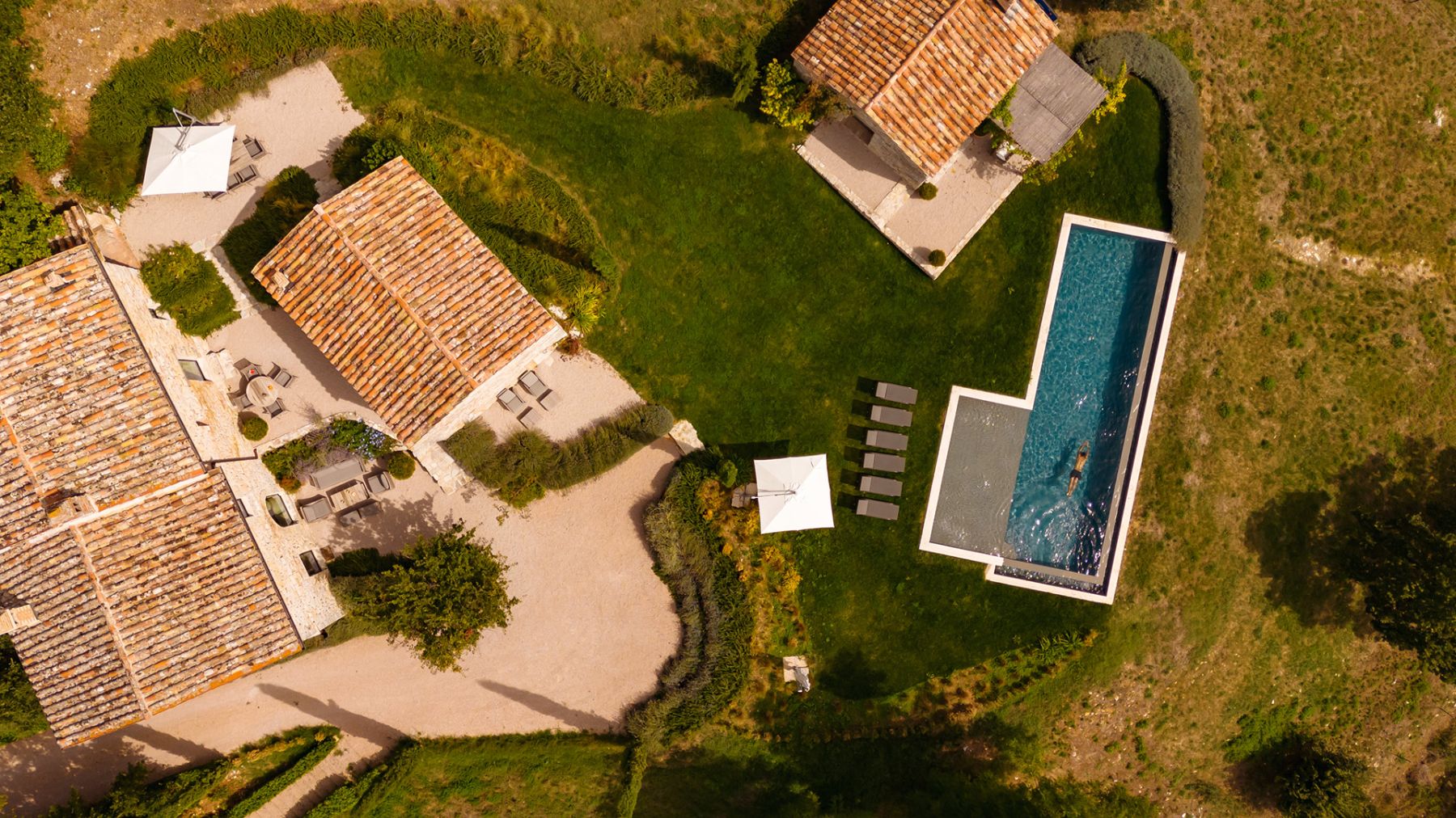 Overhead view of Villa Piuma in Umbria with view of the villa and outdoor pool with lots of green outdoor space