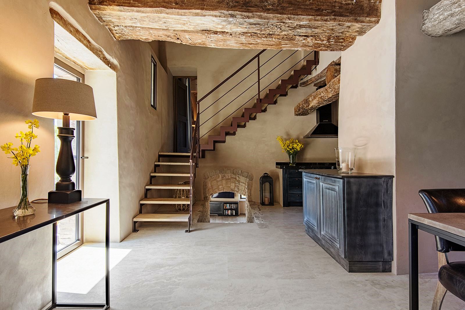 Hallway with stairs upstairs and steps downstairs to kitchen at Villa Piuma in Umbria, Italy