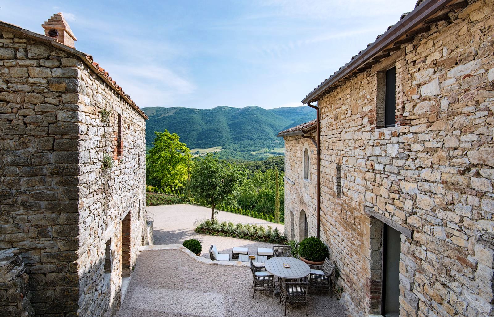 View in between main house and annex of mountains at Villa Piuma in Umbria, Italy