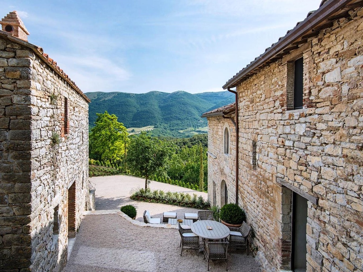 View in between main house and annex of mountains at Villa Piuma in Umbria, Italy