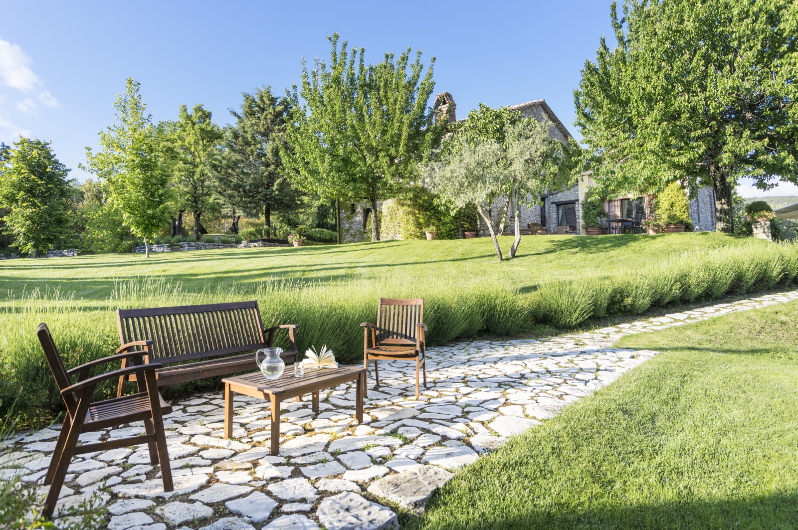 Paved pathway with seating at Villa Pizzicato in Umbria
