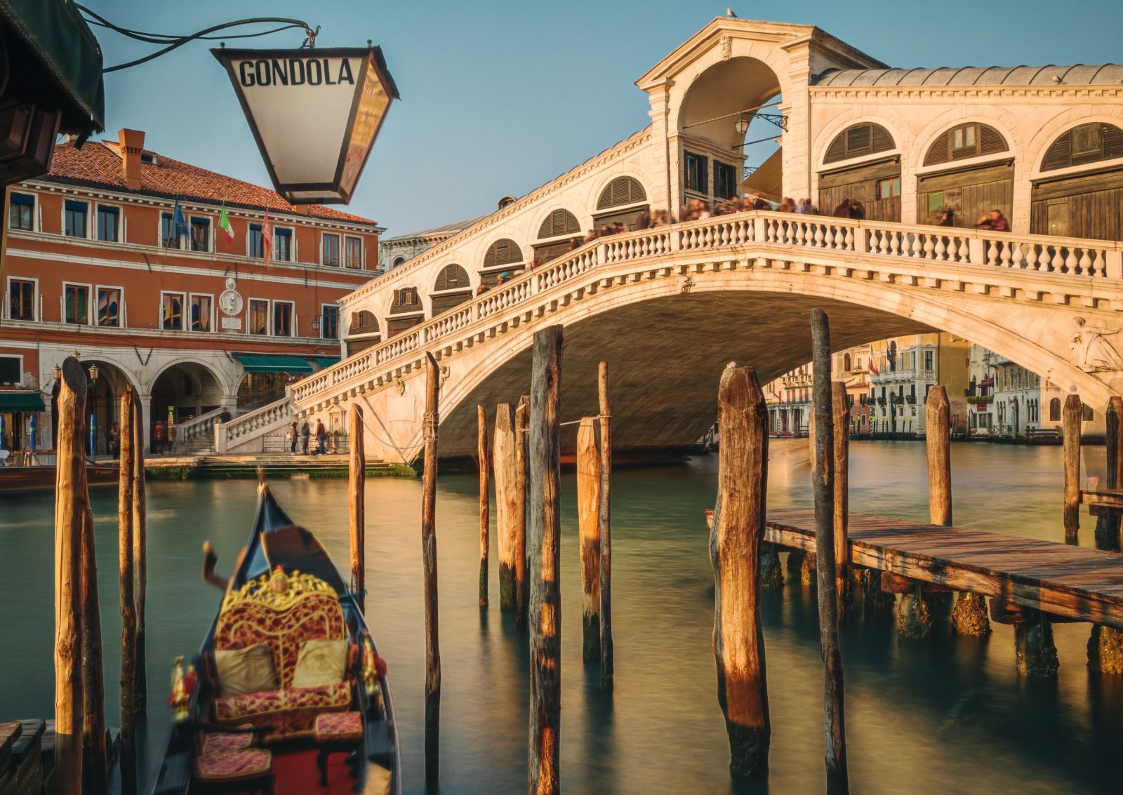 A gondola sailing beneath the Rialto Bridge in Venice