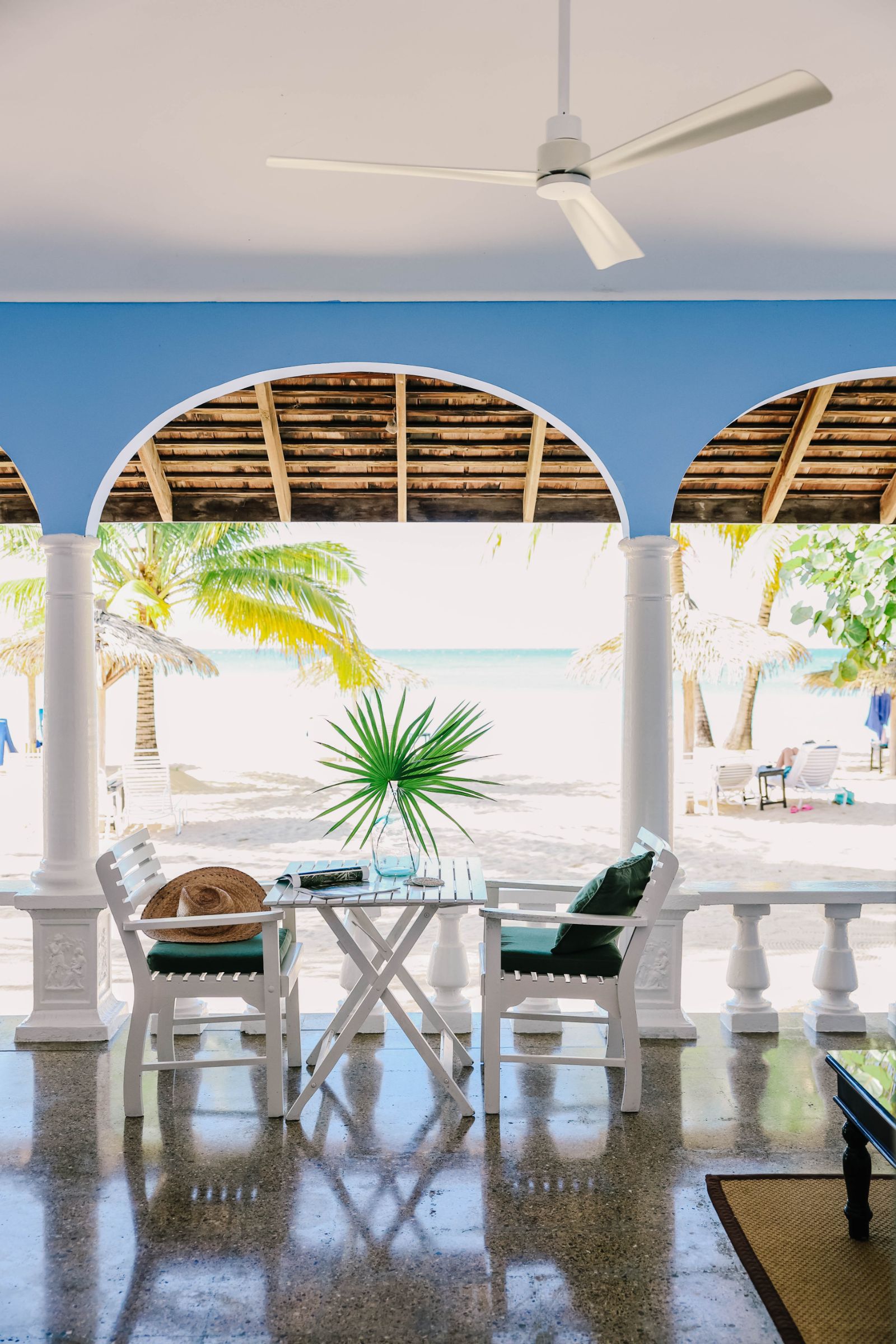 Shaded seating overlooking the beach and sea at luxury resort Jamaica Inn in Jamaica