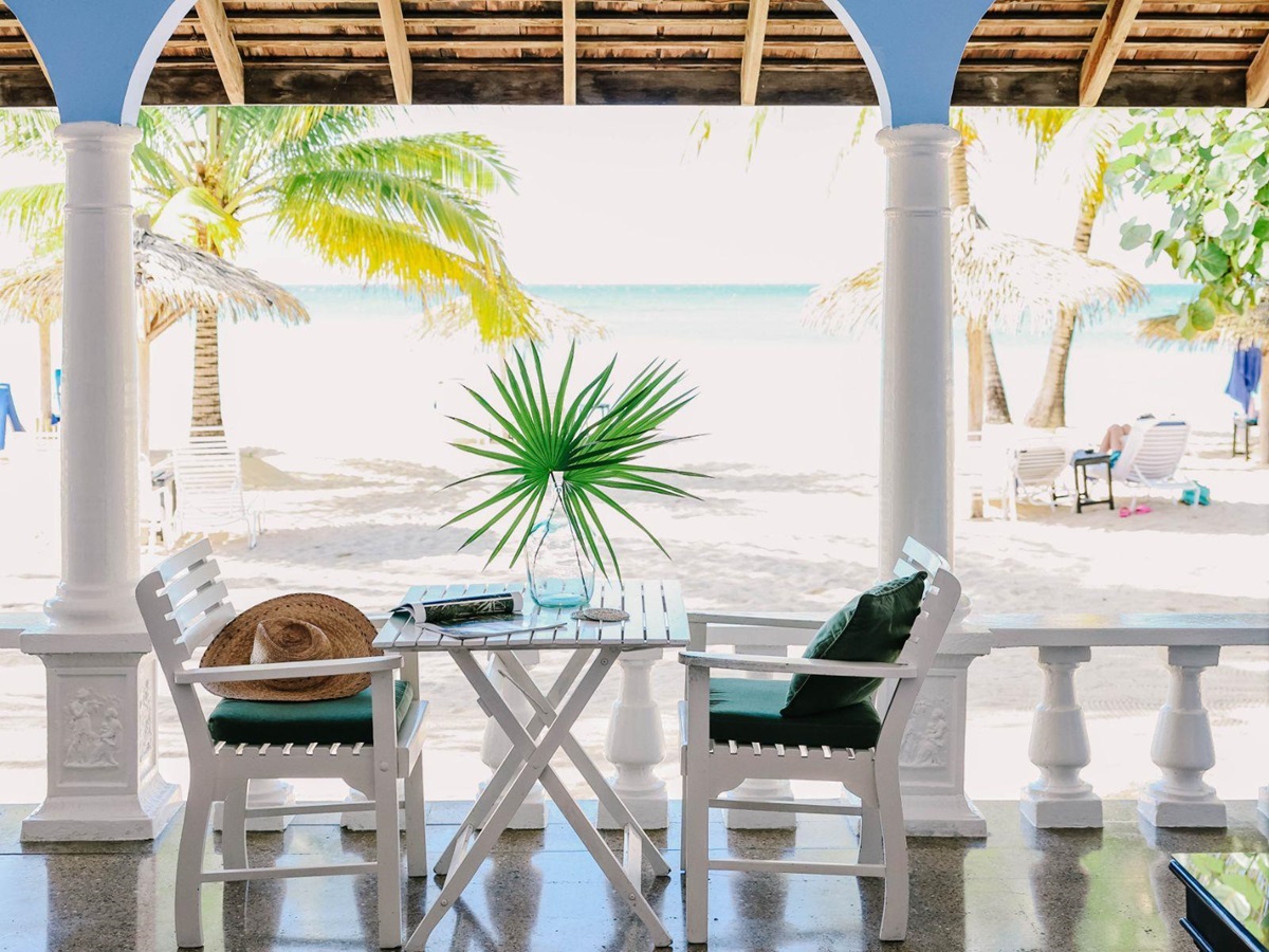 Shaded seating overlooking the beach and sea at luxury resort Jamaica Inn in Jamaica