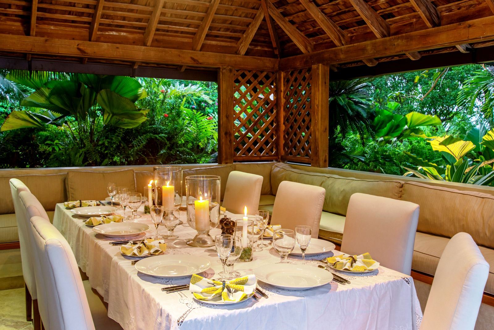 dining table set for dinner with white cloth, plates and candles at Almond Hill Villa, Montego Bay Jamaica