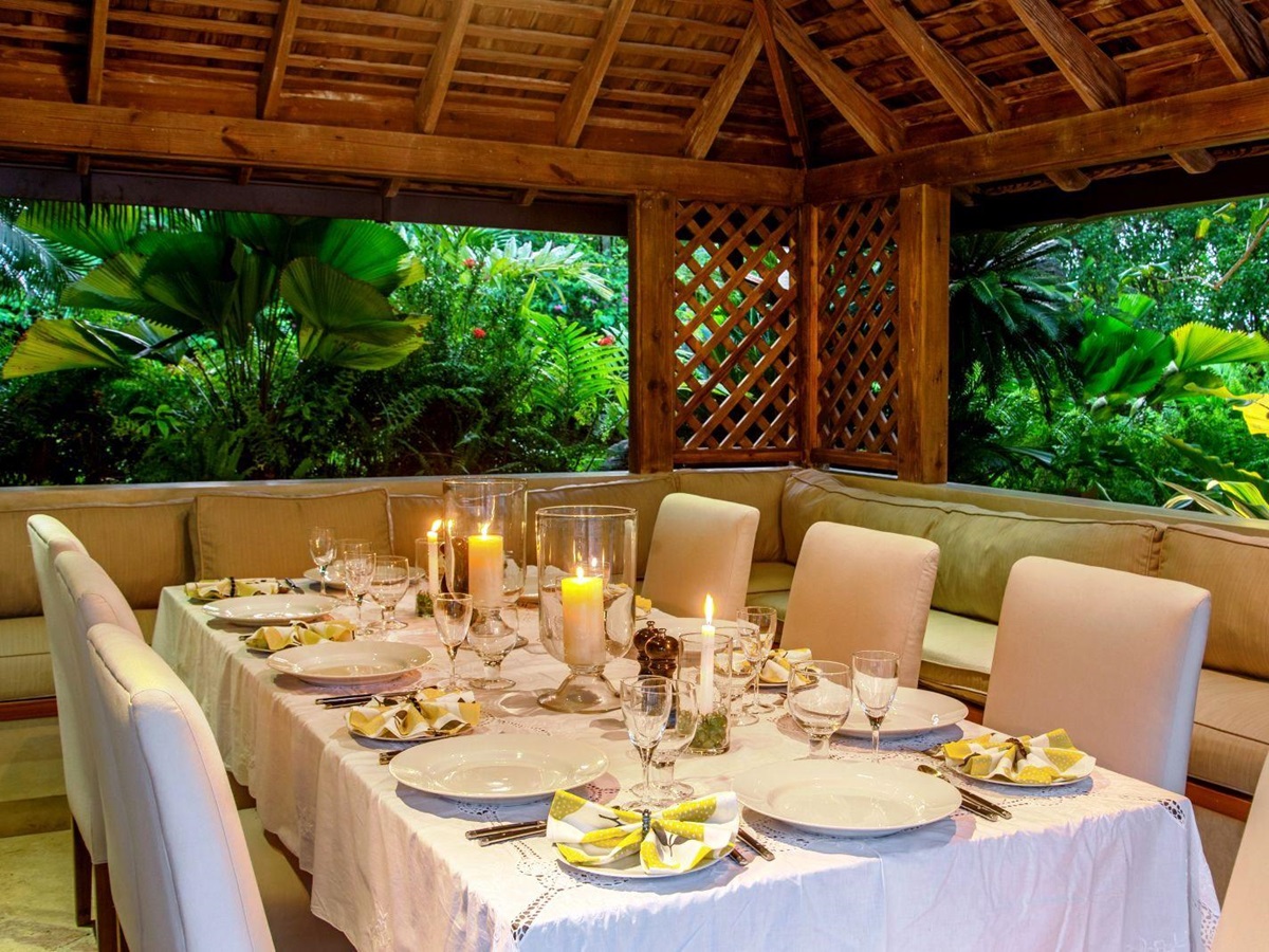 dining table set for dinner with white cloth, plates and candles at Almond Hill Villa, Montego Bay Jamaica