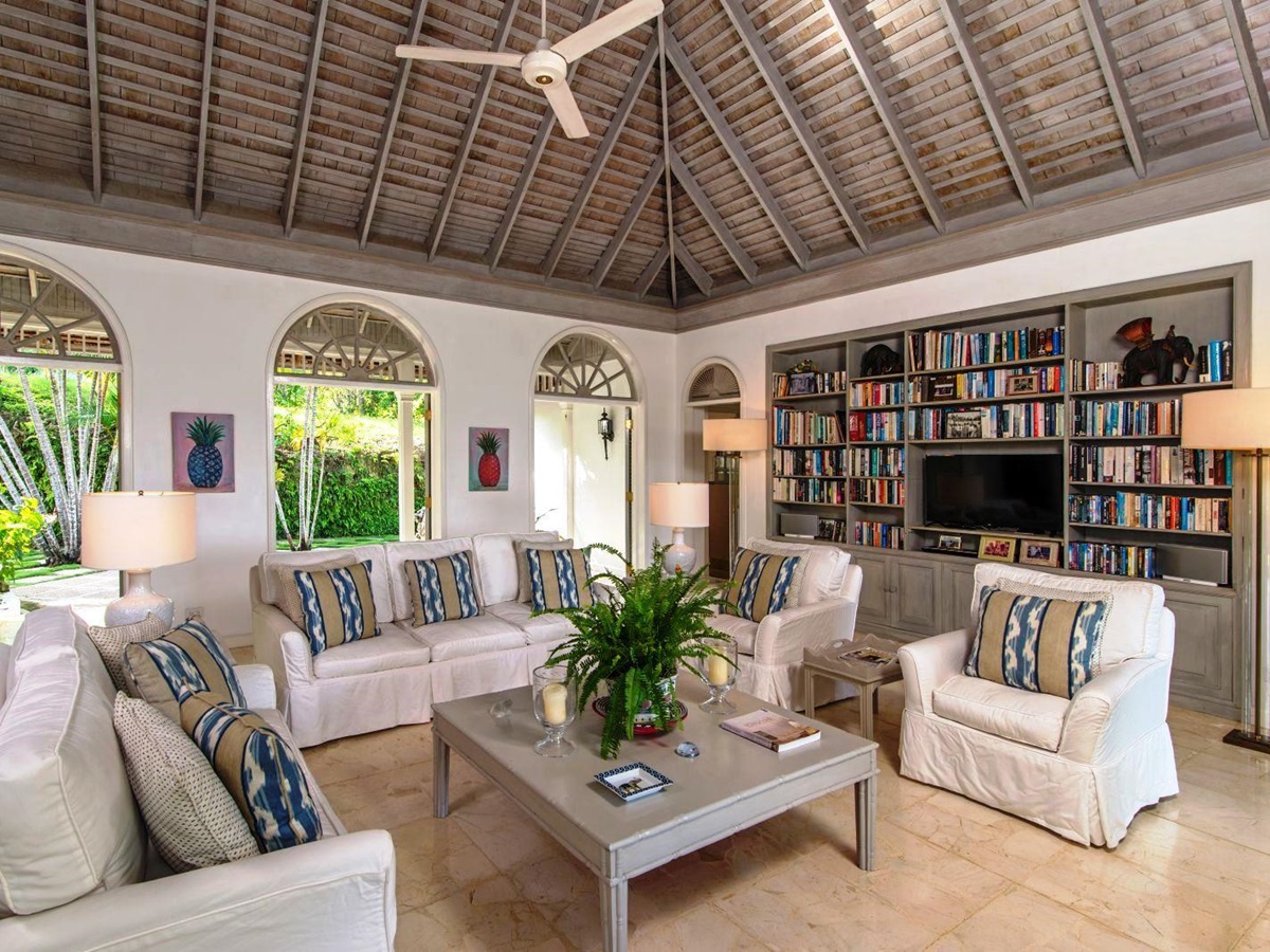 sitting area with white couches, coffee table and book shelves at Almond Hill Villa, Montego Bay Jamaica