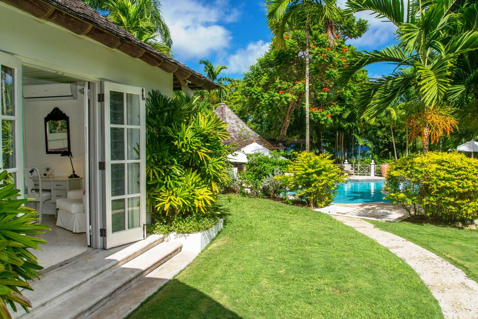 garden path next to house leading to pool at Almond Hill Villa, Montego Bay Jamaica