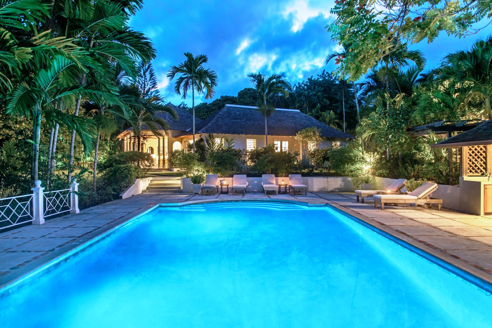 view over the pool to the house at night at Almond Hill Villa, Montego Bay Jamaica