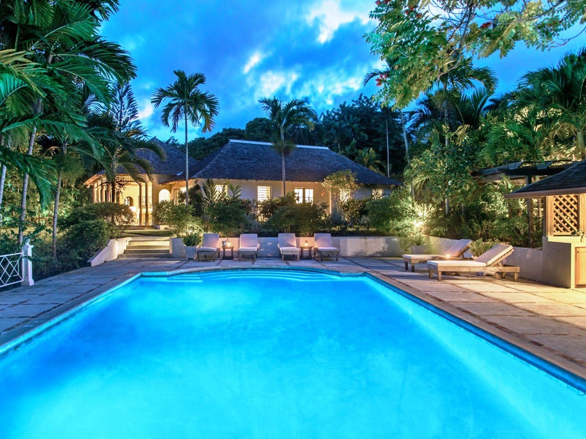 view over the pool to the house at night at Almond Hill Villa, Montego Bay Jamaica