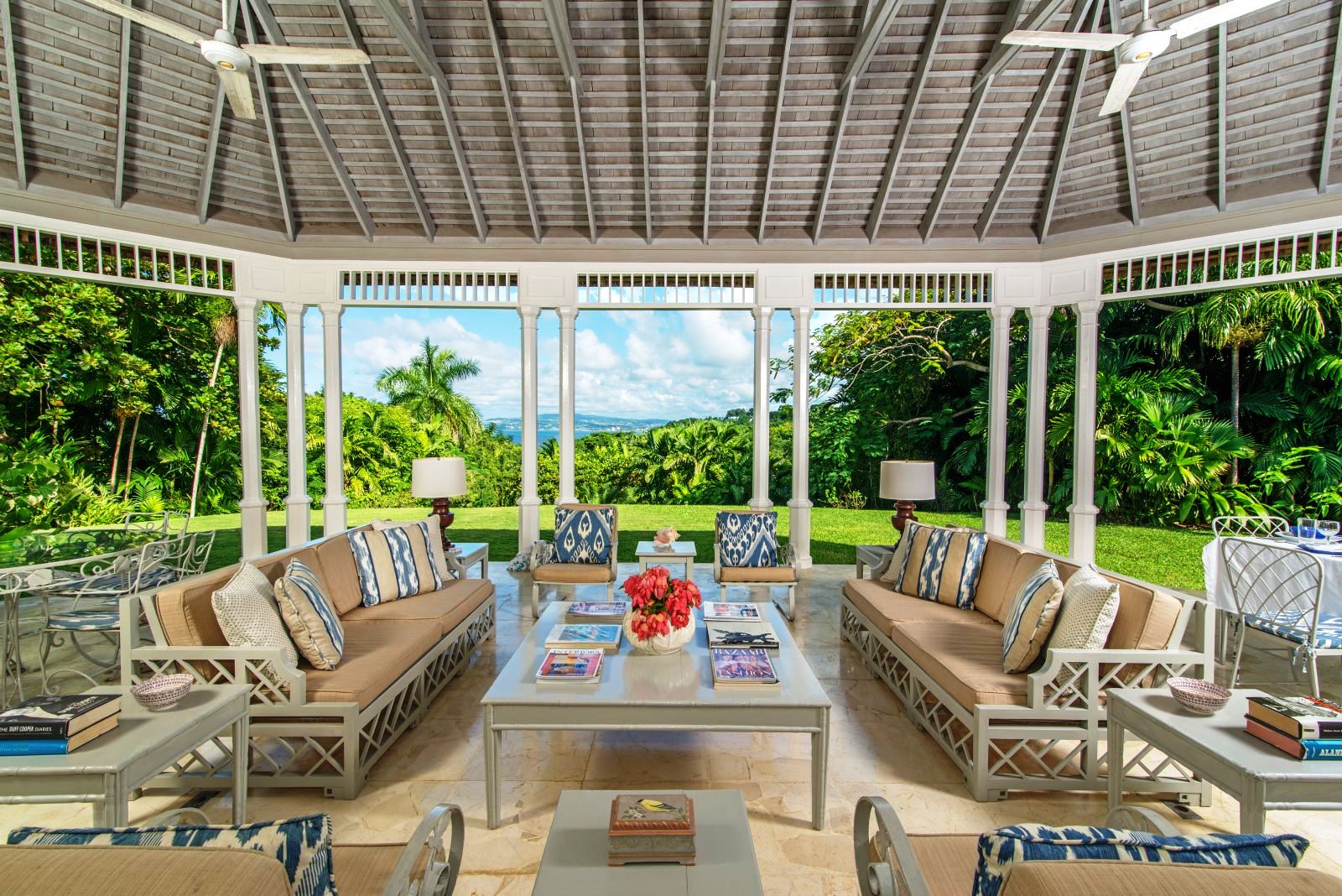 conservatory area with comfy furniture and view over Montego Bay at Almond Hill villa