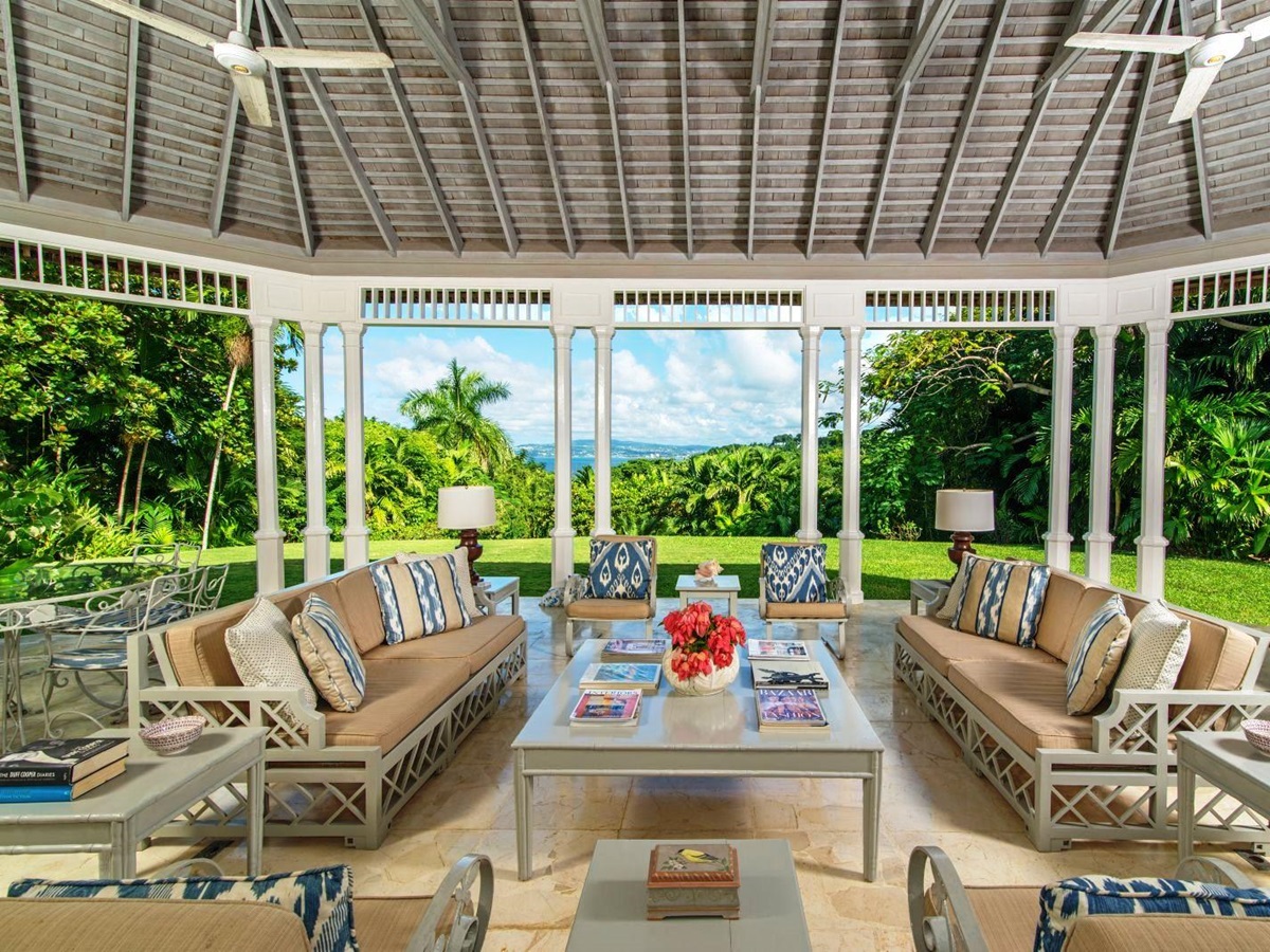 conservatory area with comfy furniture and view over Montego Bay at Almond Hill villa