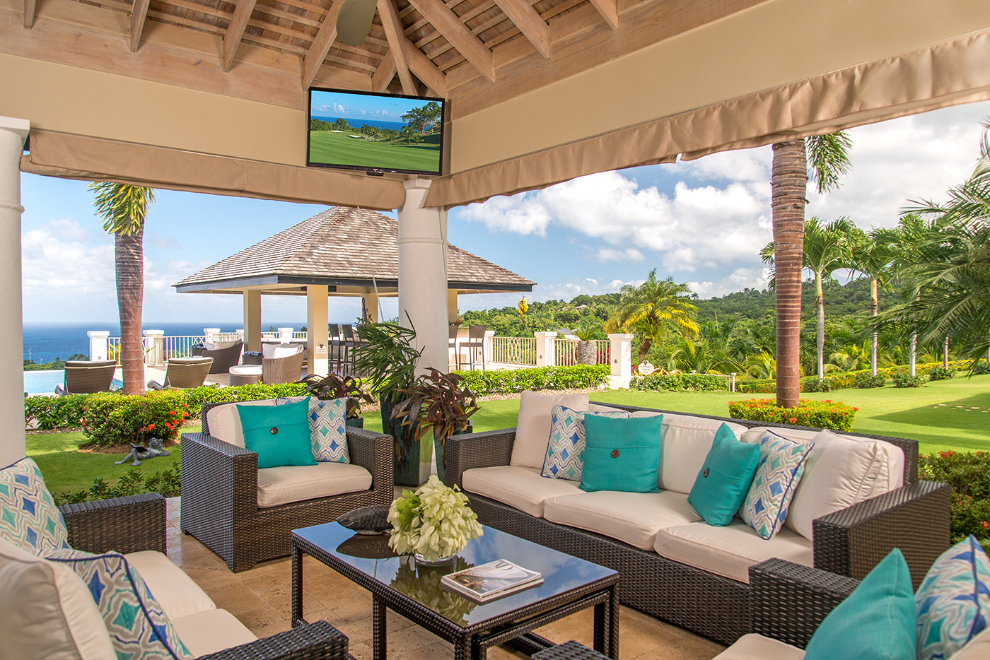 Outdoor sitting area with TV at Harmony Hill in Jamaica