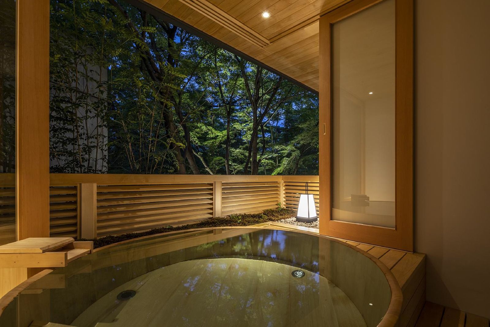 A private onsen tub lantern lit by night at Beniya Mukayu ryokan in Japan