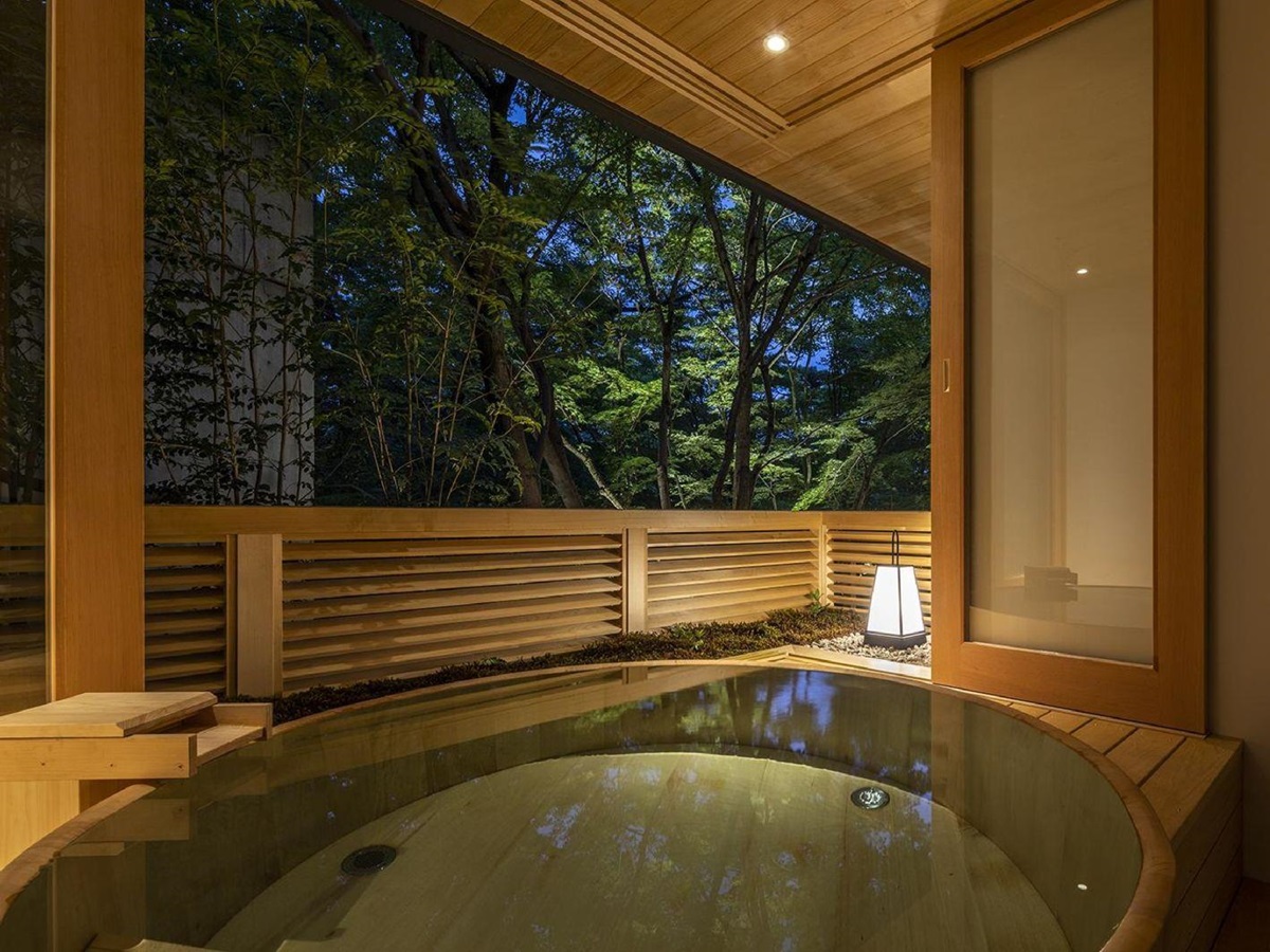 A private onsen tub lantern lit by night at Beniya Mukayu ryokan in Japan