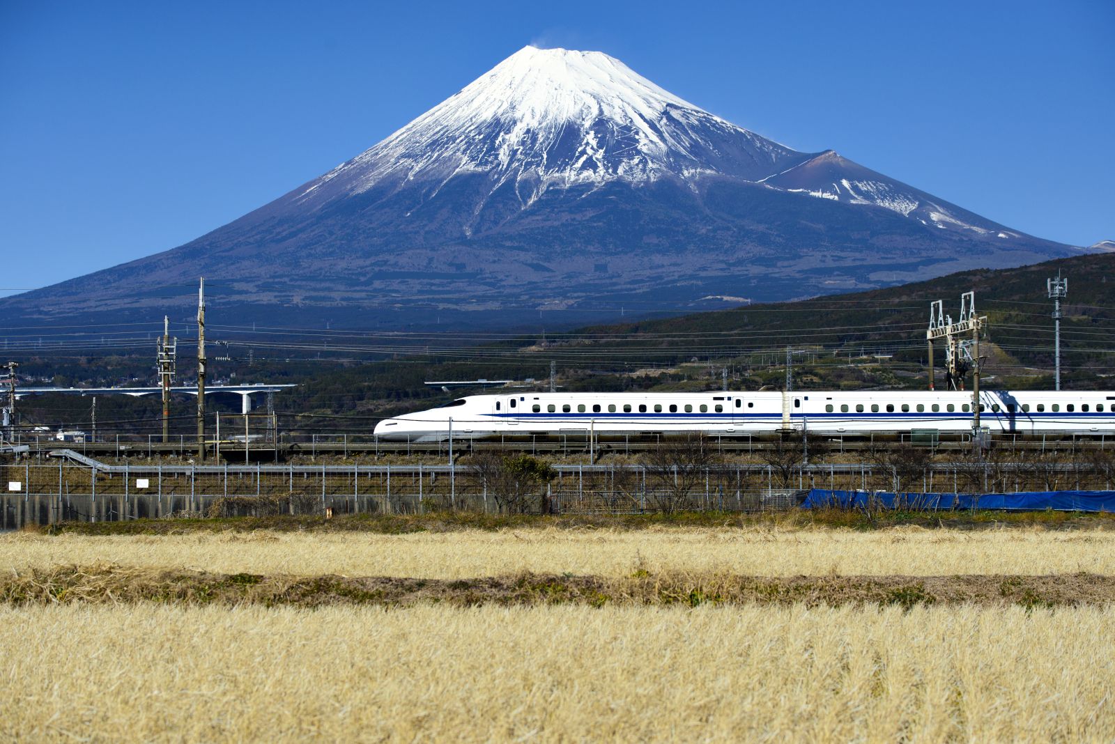 A bullet train and distant view of Mount Fuji in Japan