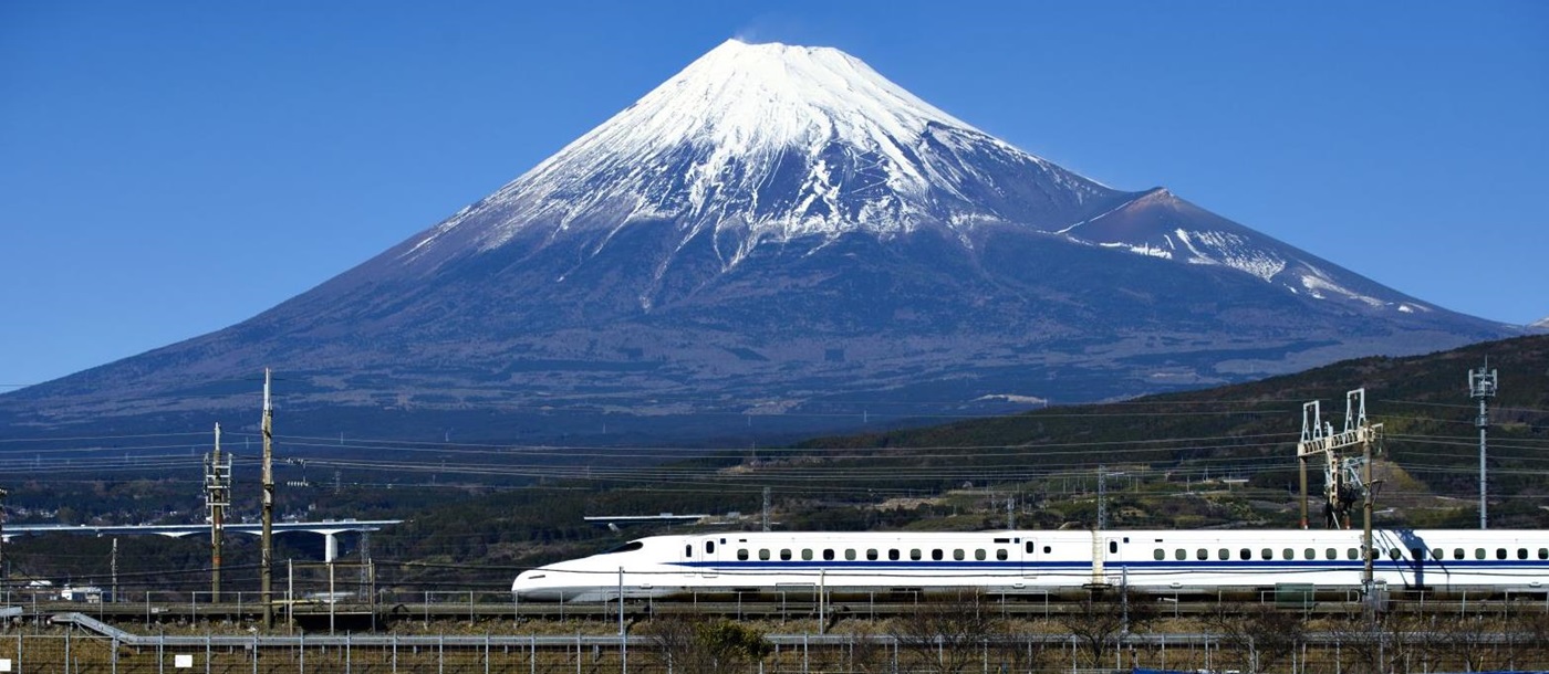 A bullet train and distant view of Mount Fuji in Japan