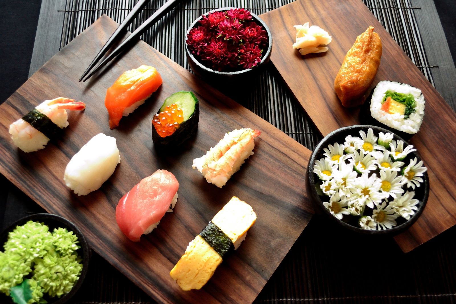 A wooden serving board displaying traditional Japanese sushi