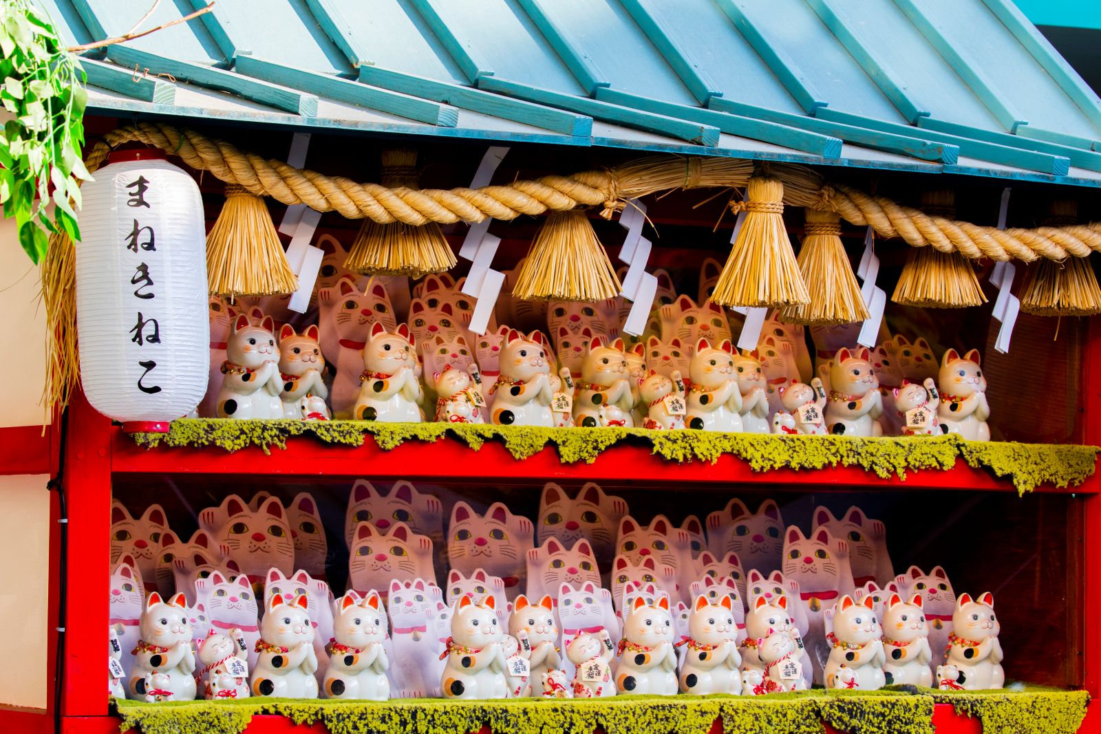 Typical Japanese lucky cats for sale at a stall in Tokyo