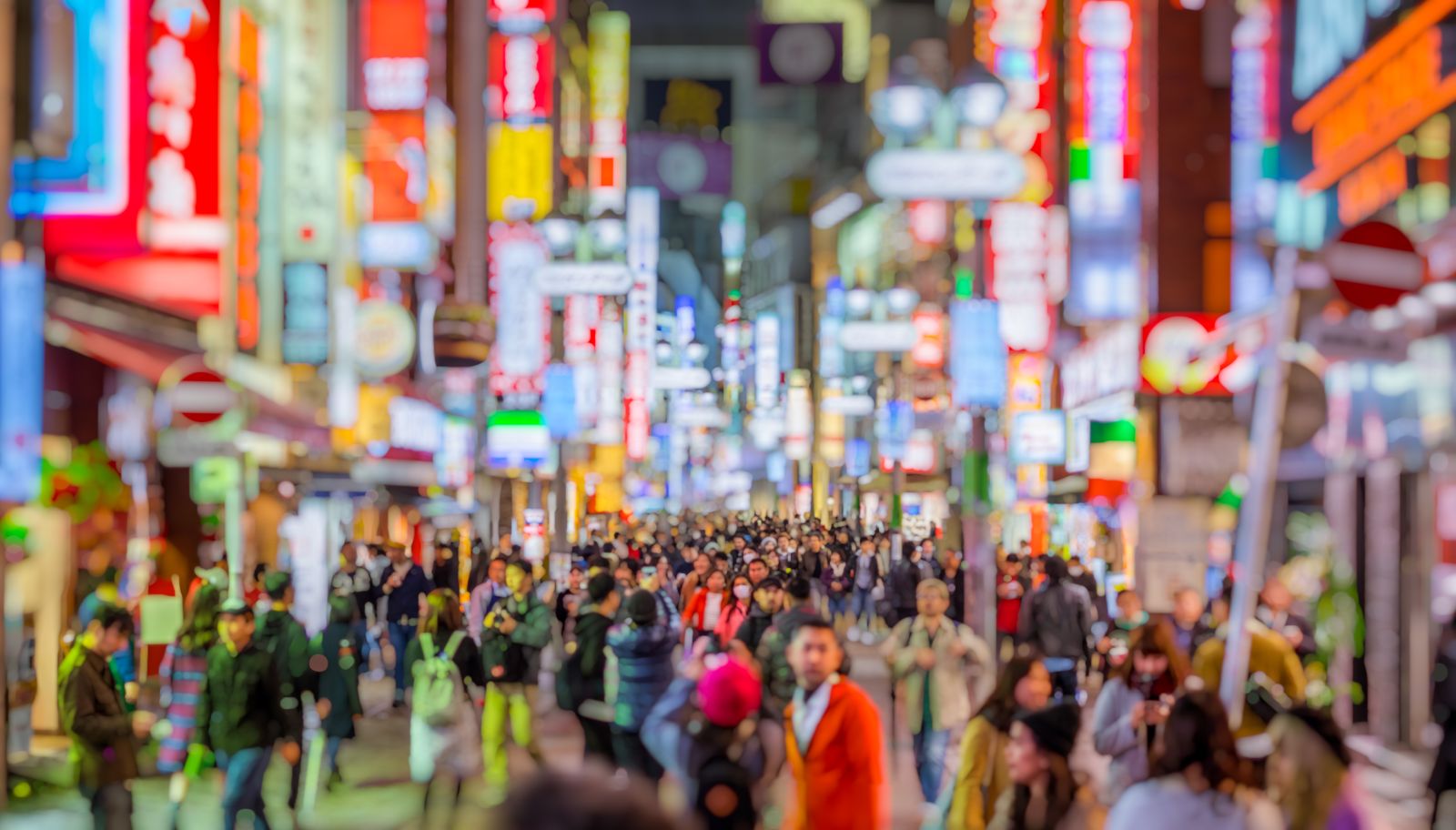 Crowds and neon lights in a Tokyo street by night