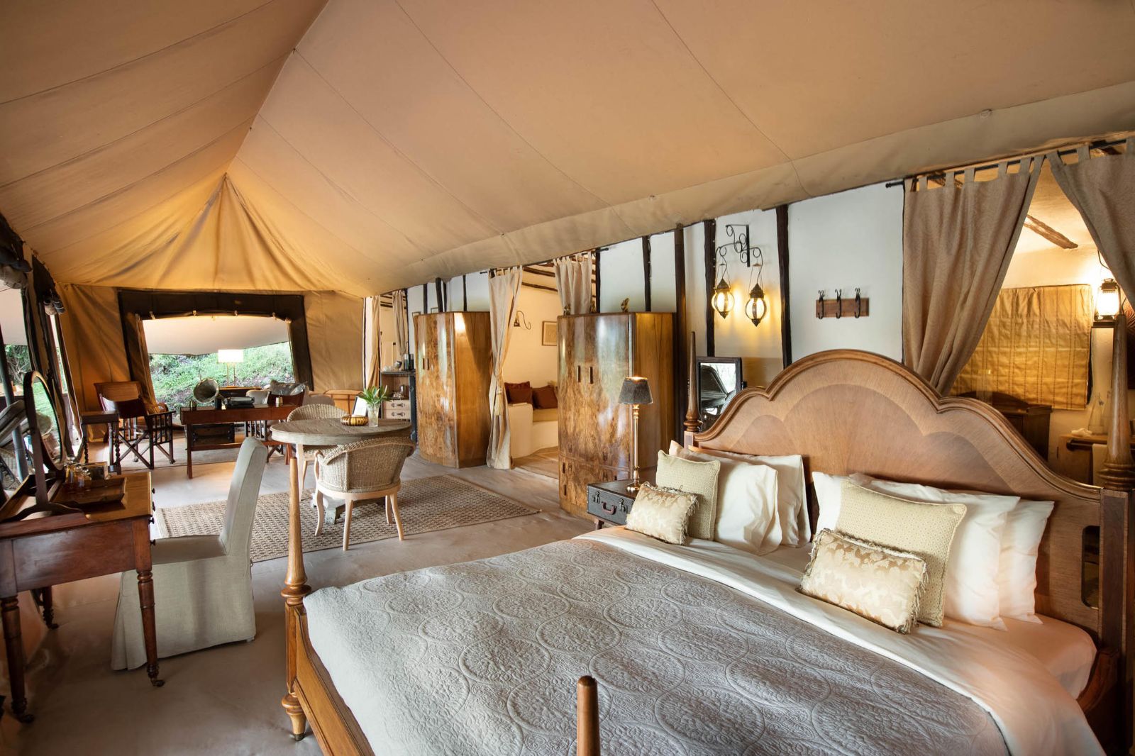 Honeymoon tent bedroom with lounge and dining area at luxury lodge Cottar's 1920s Camp in the Maasai Mara, Kenya