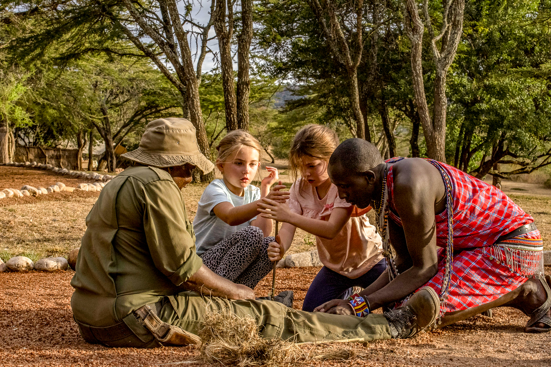 Children lighting a fire at Maasai Warrior School at Cottar's 1920s Camp in Kenya