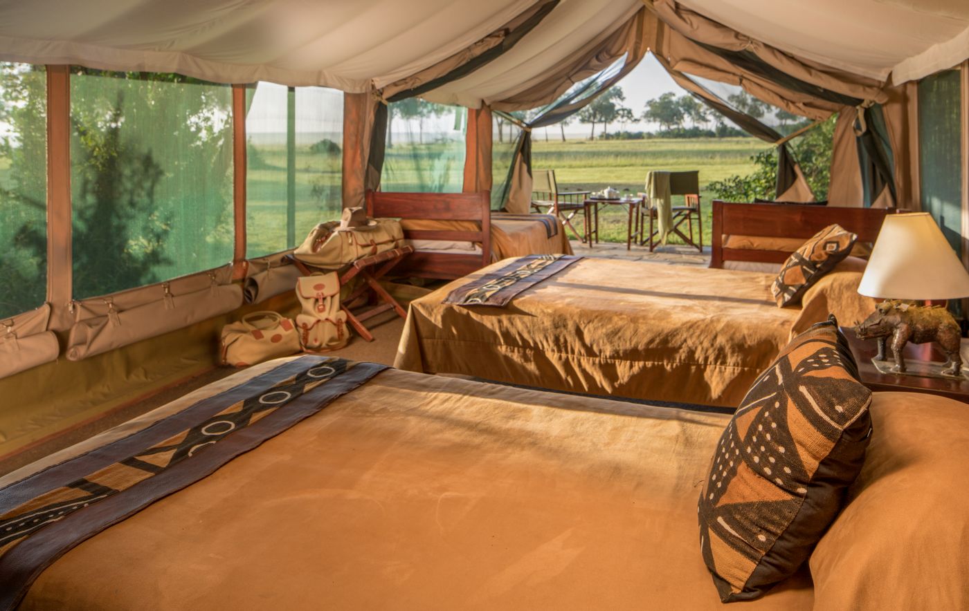 The interior of a luxury tent with beds at Governors Camp in Kenya
