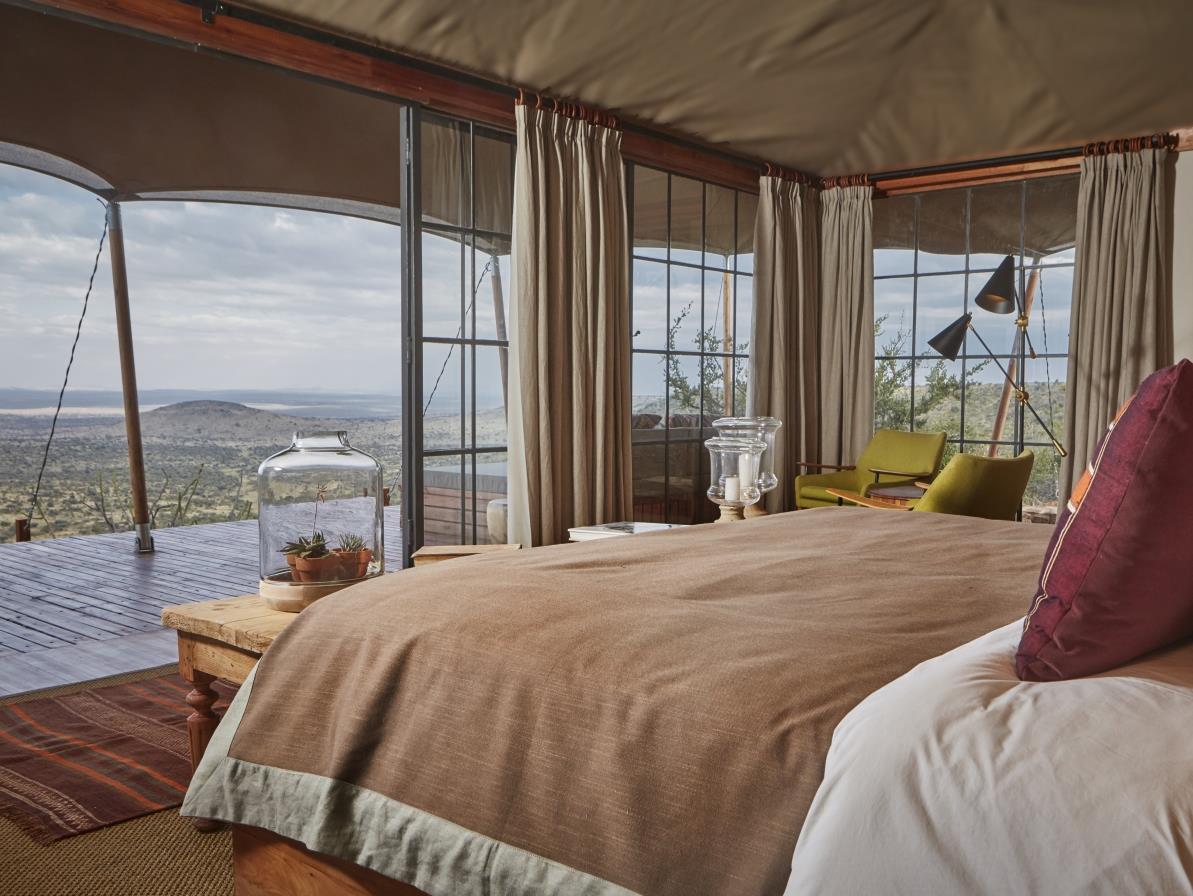 Double tented room with private verandah at luxury safari lodge Lodo Springs in the Laikipia region of Kenya