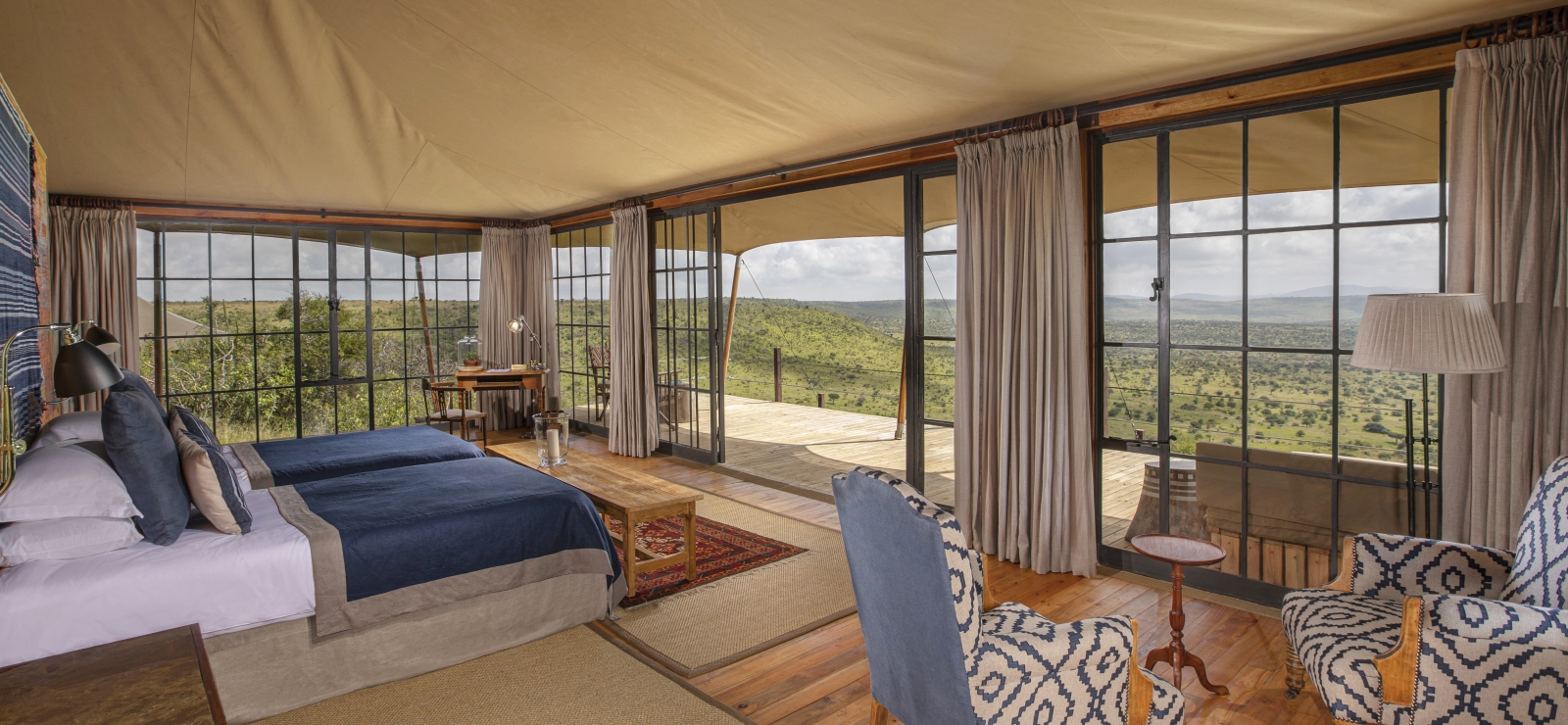 Luxury twin tented room with private verandah and sitting area at luxury safari lodge Lodo Springs in the Laikipia region of Kenya