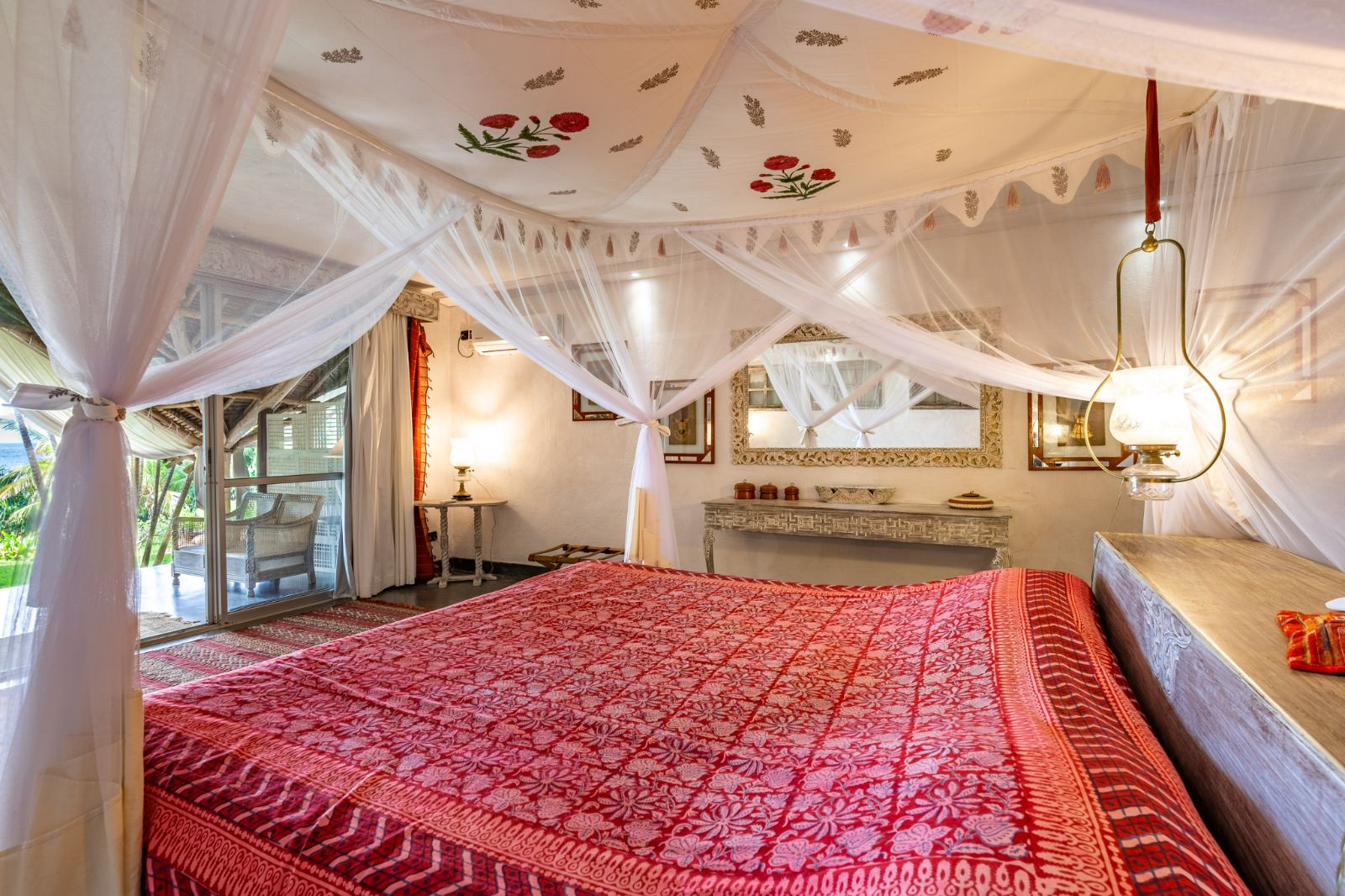 Red guest suite bedroom at Alfajiri Garden Villa on Diani Beach in Kenya
