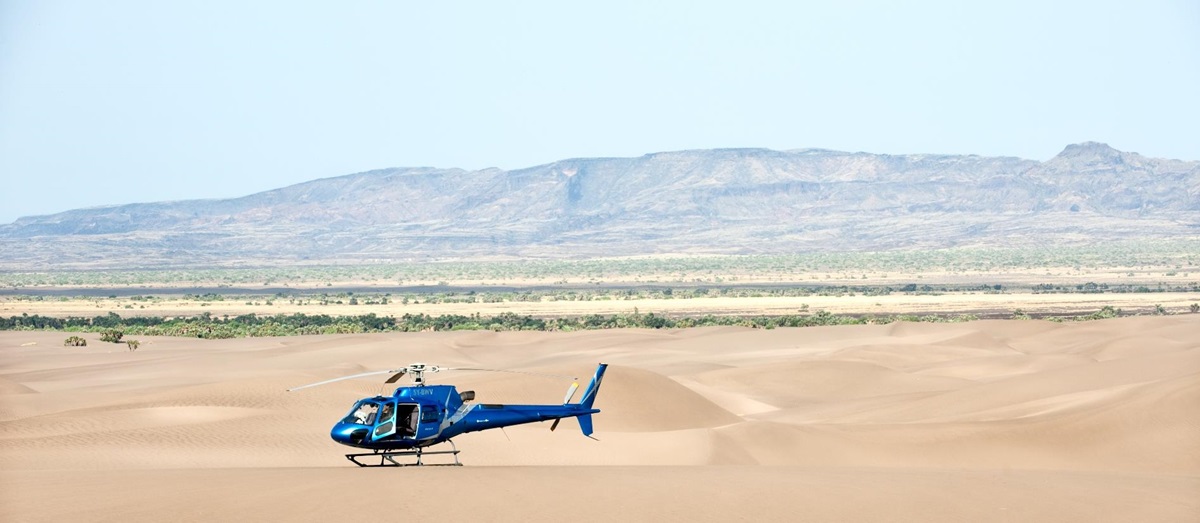 A helicopter flying over the Kenyan desert