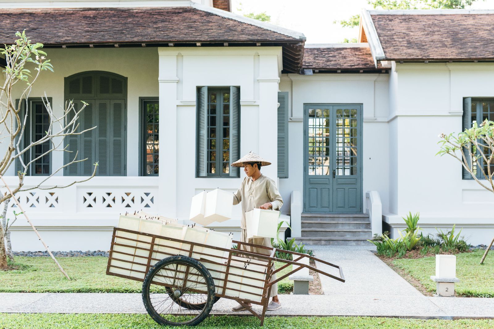 Gardener in traditional dress at Amantaka in Luang Prabang Laos