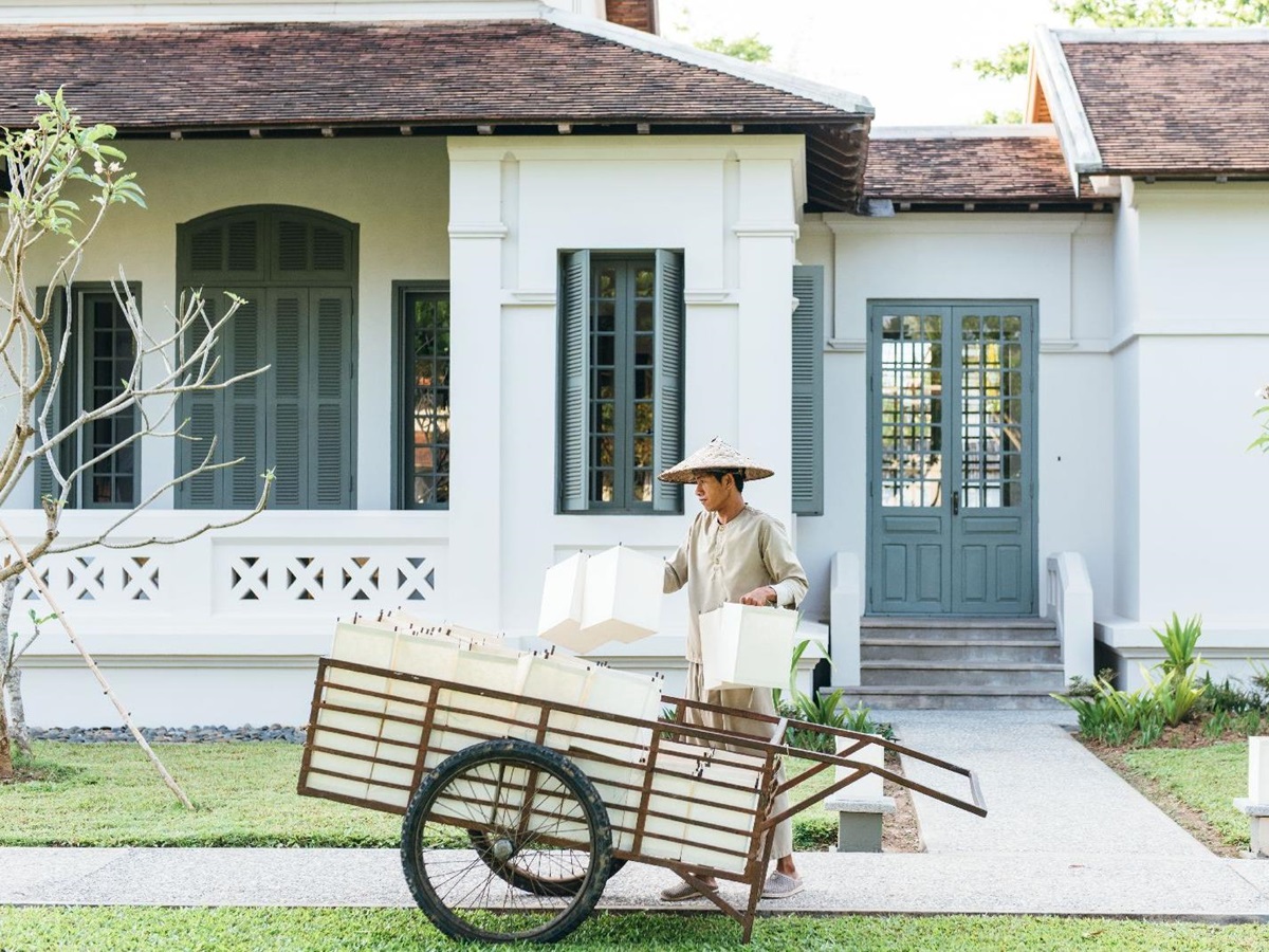 Gardener in traditional dress at Amantaka in Luang Prabang Laos