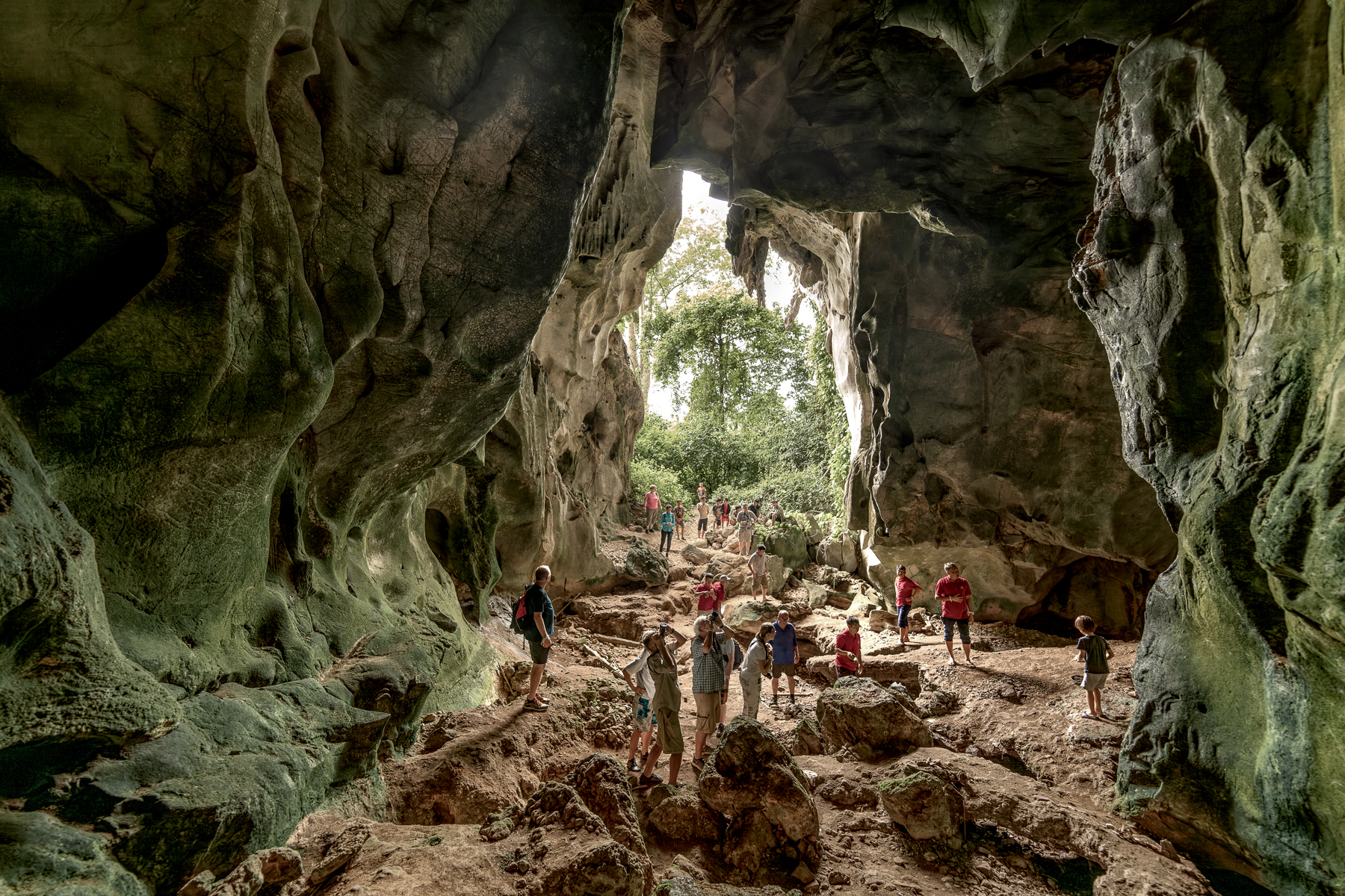 Guests of the Anouvong luxury river cruiser exploring caves on Laos' Upper Mekong