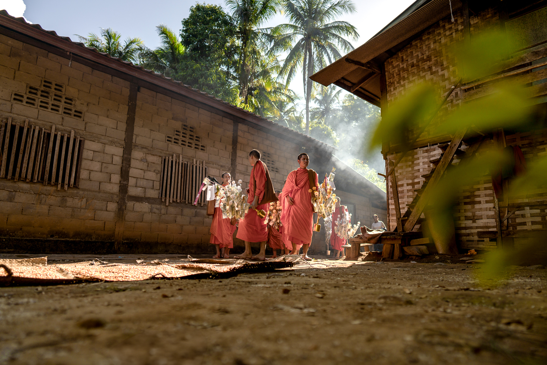 Monks walking around a village along the Upper Mekong in Laos