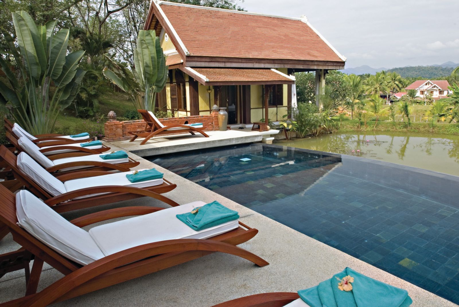 Sunbeds along the poolside at La Residence Phao Vao in Luang Prabang, Laos