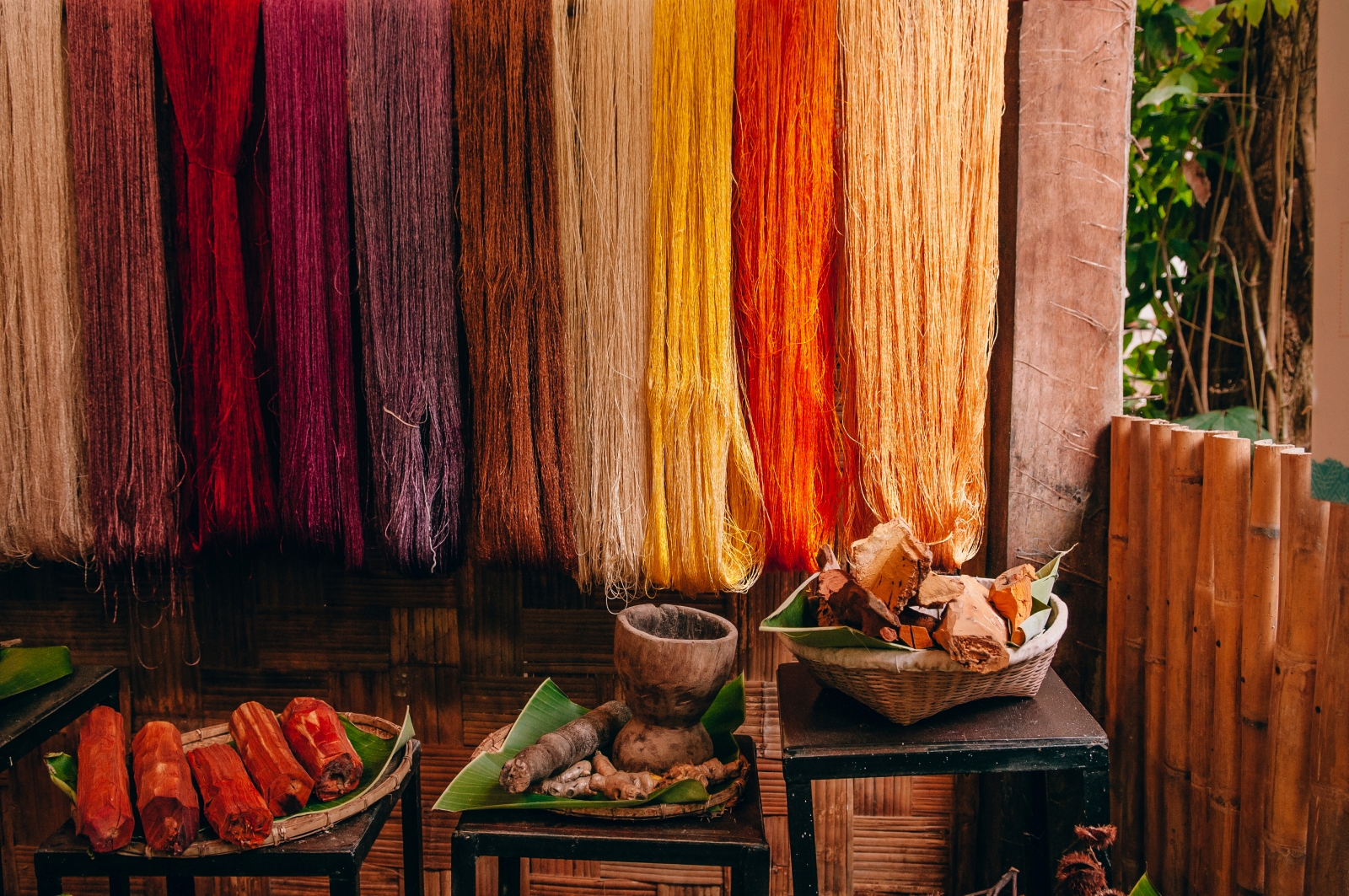 Coloured fabric hanging in a wooden room
