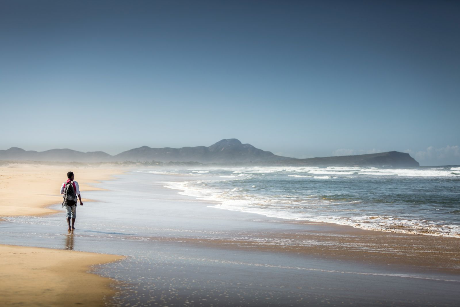 A woman walking on the beach of the sand dunes near Mandrare River Camp in Madagascar