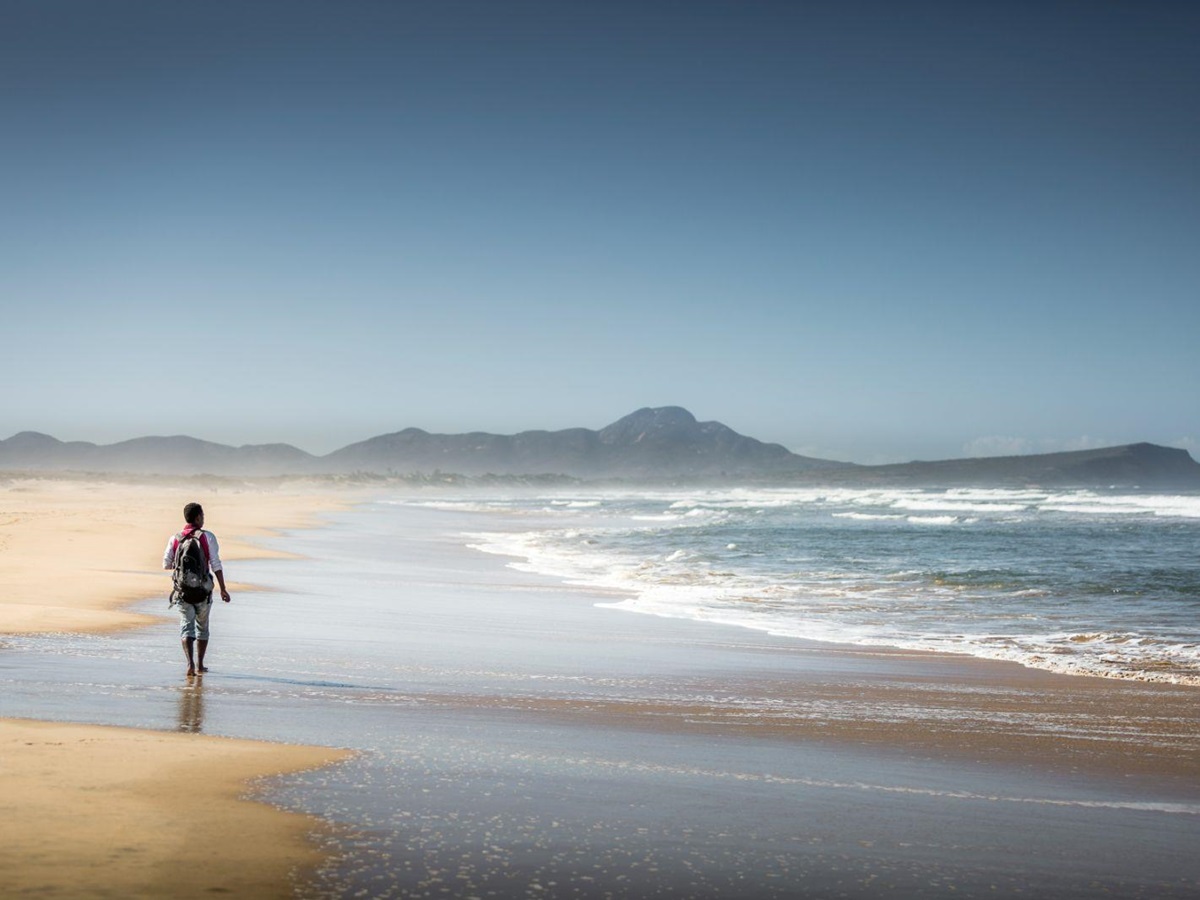 A woman walking on the beach of the sand dunes near Mandrare River Camp in Madagascar