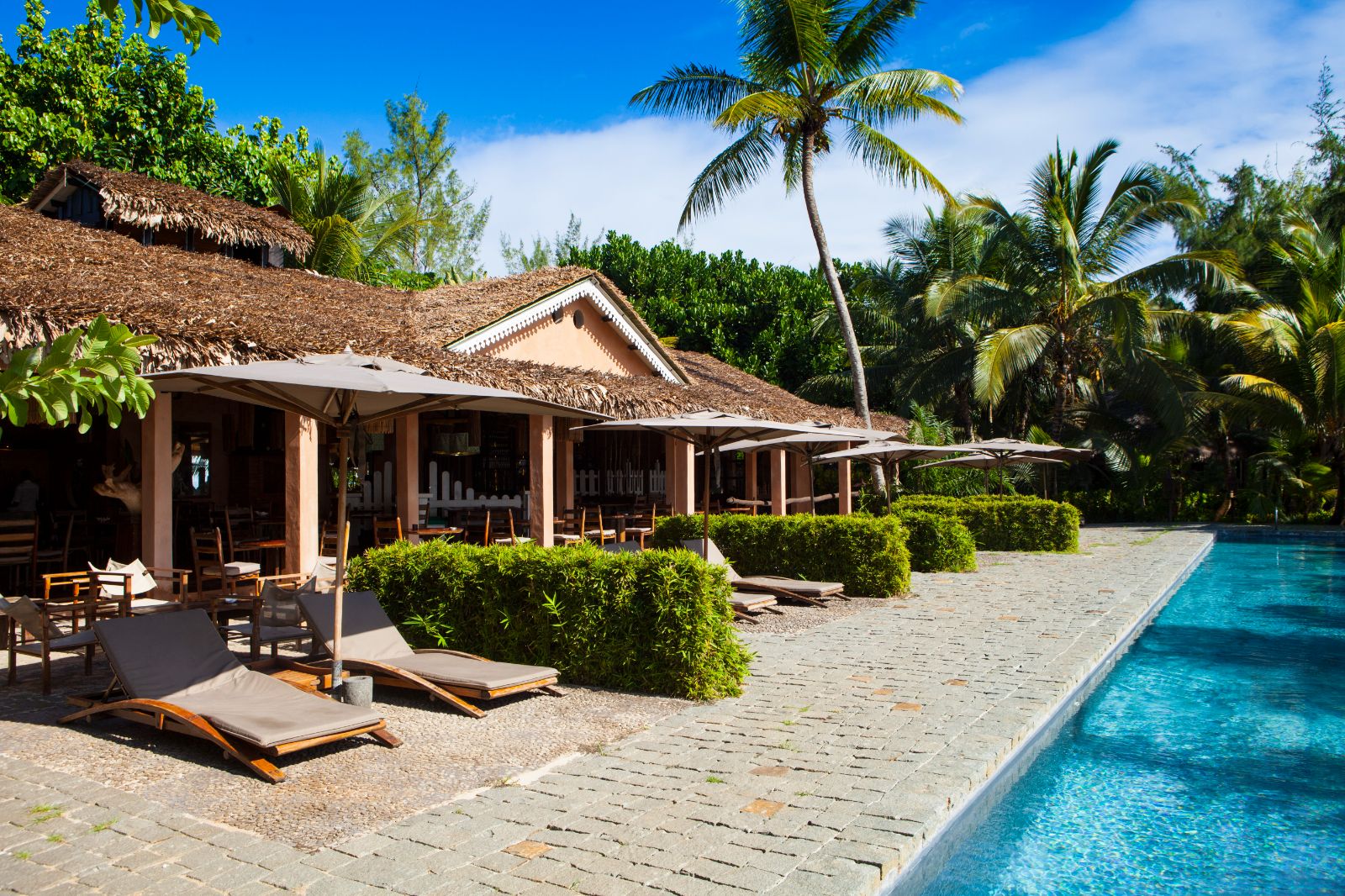 Poolside building and loungers at Princesse Bora Lodge & Spa on Sainte-Marie Island in Madagascar
