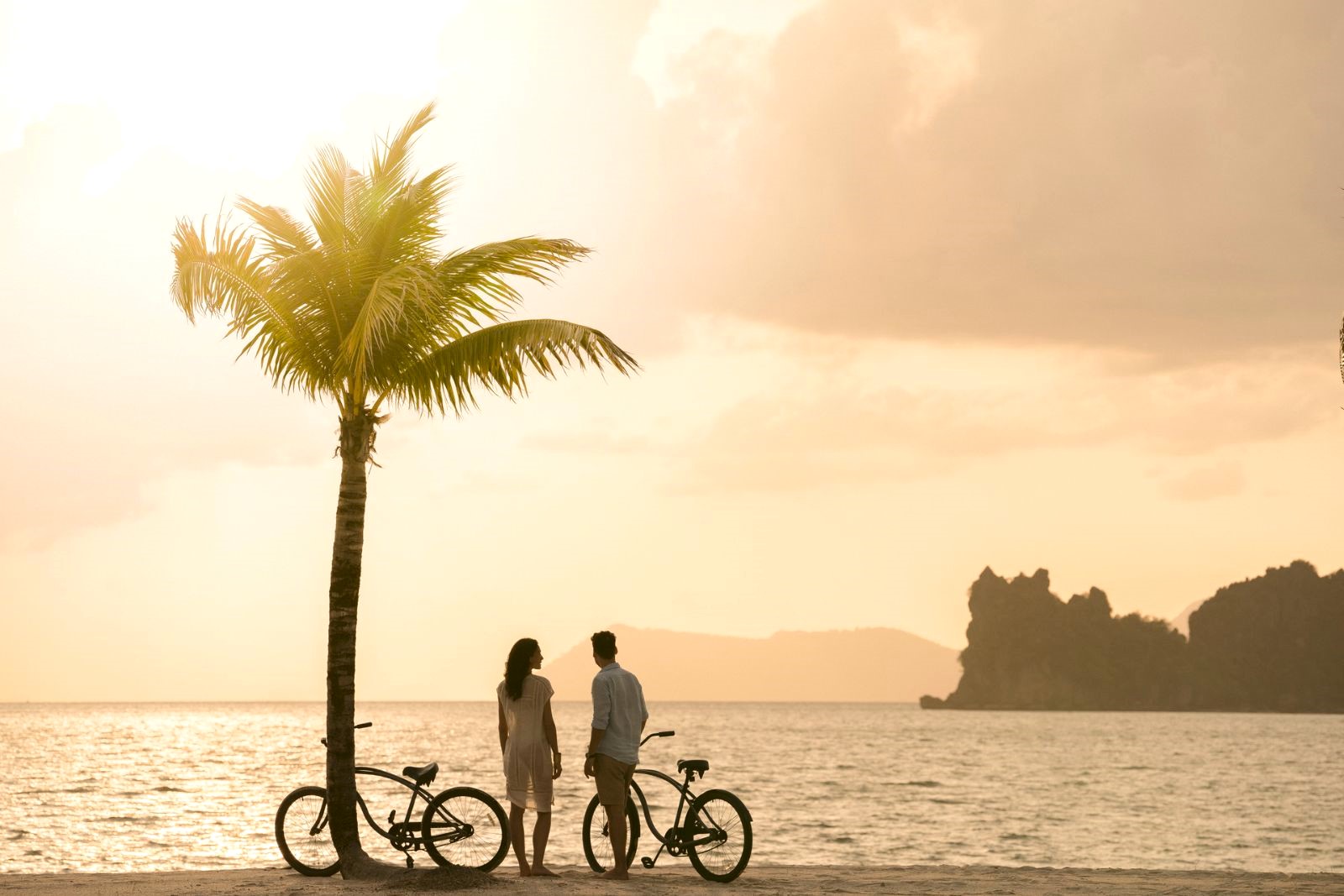 Cycling on the beach at Four Seasons Langkawi resort in Malaysia