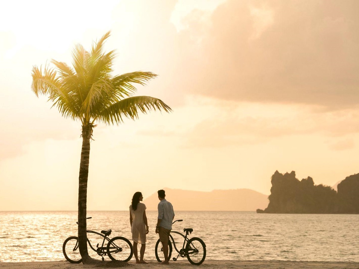 Cycling on the beach at Four Seasons Langkawi resort in Malaysia