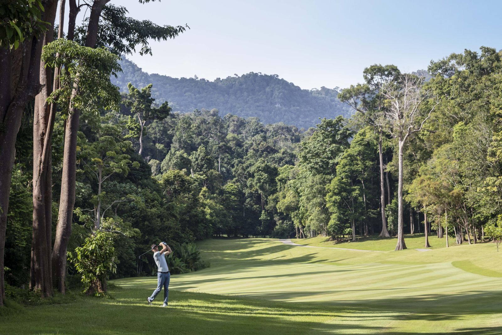 Guest playing golf on the championship course at the Datai Langkawi in Malaysia