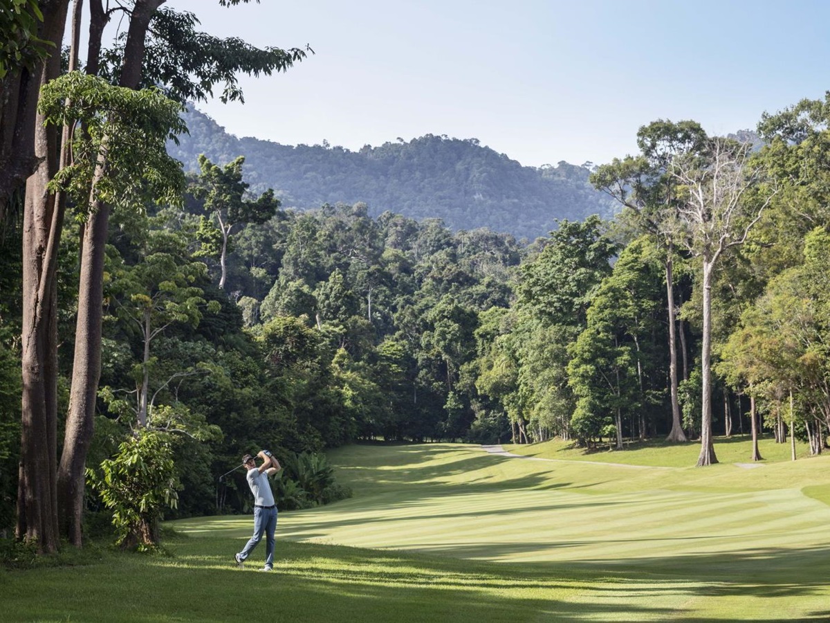 Guest playing golf on the championship course at the Datai Langkawi in Malaysia