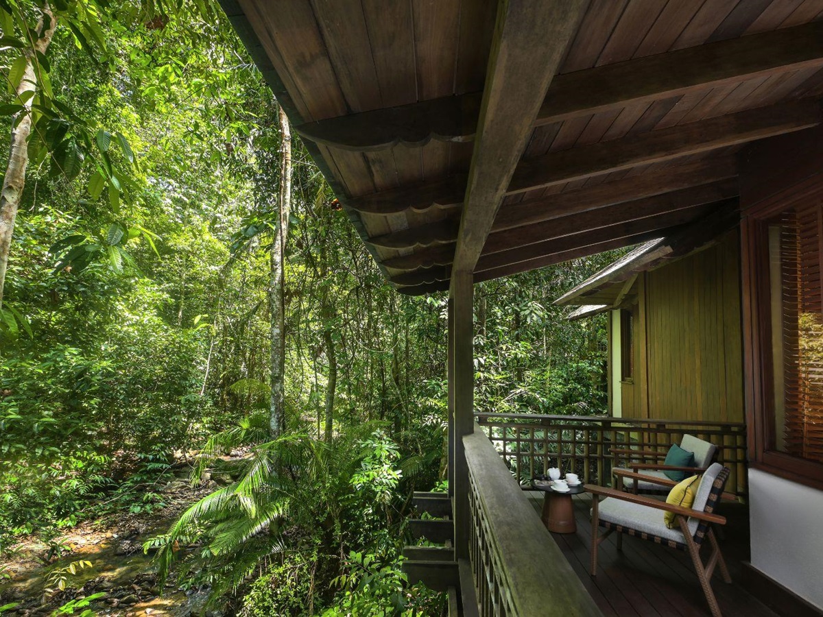 Premium villa outdoor seating area looking out to the forest at luxury resort The Datai
