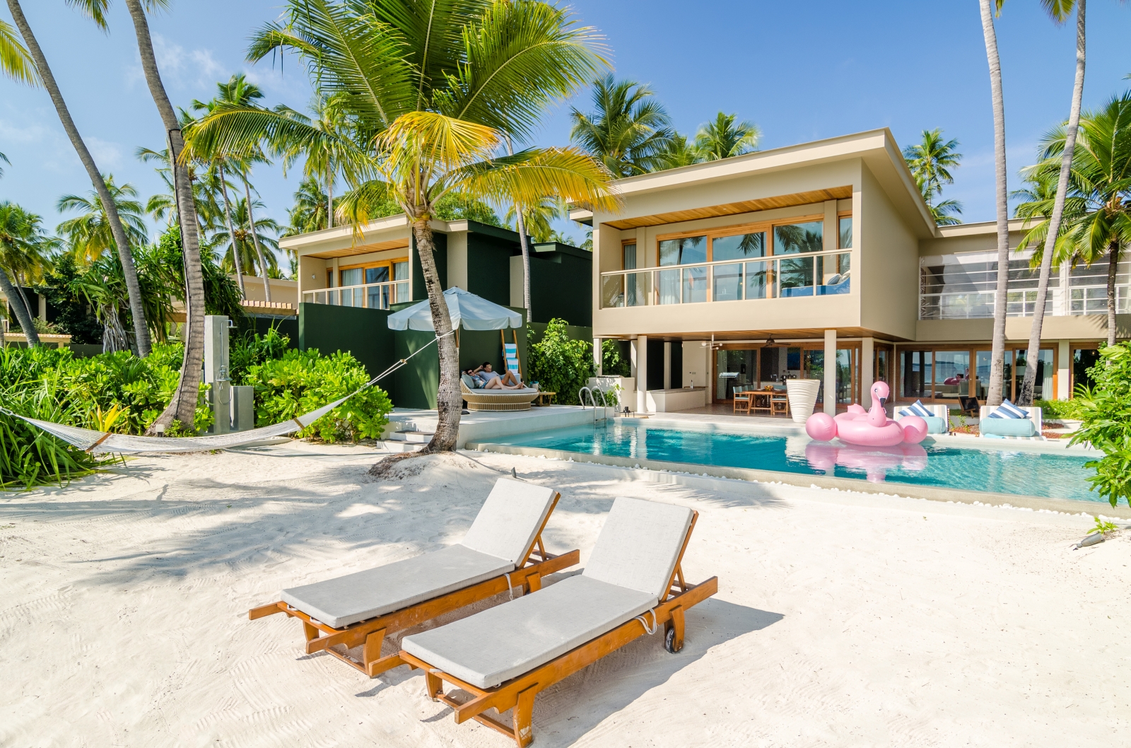 Exterior and privaet pool of a four bedroom residence at luxury resort Amilla in the Maldives