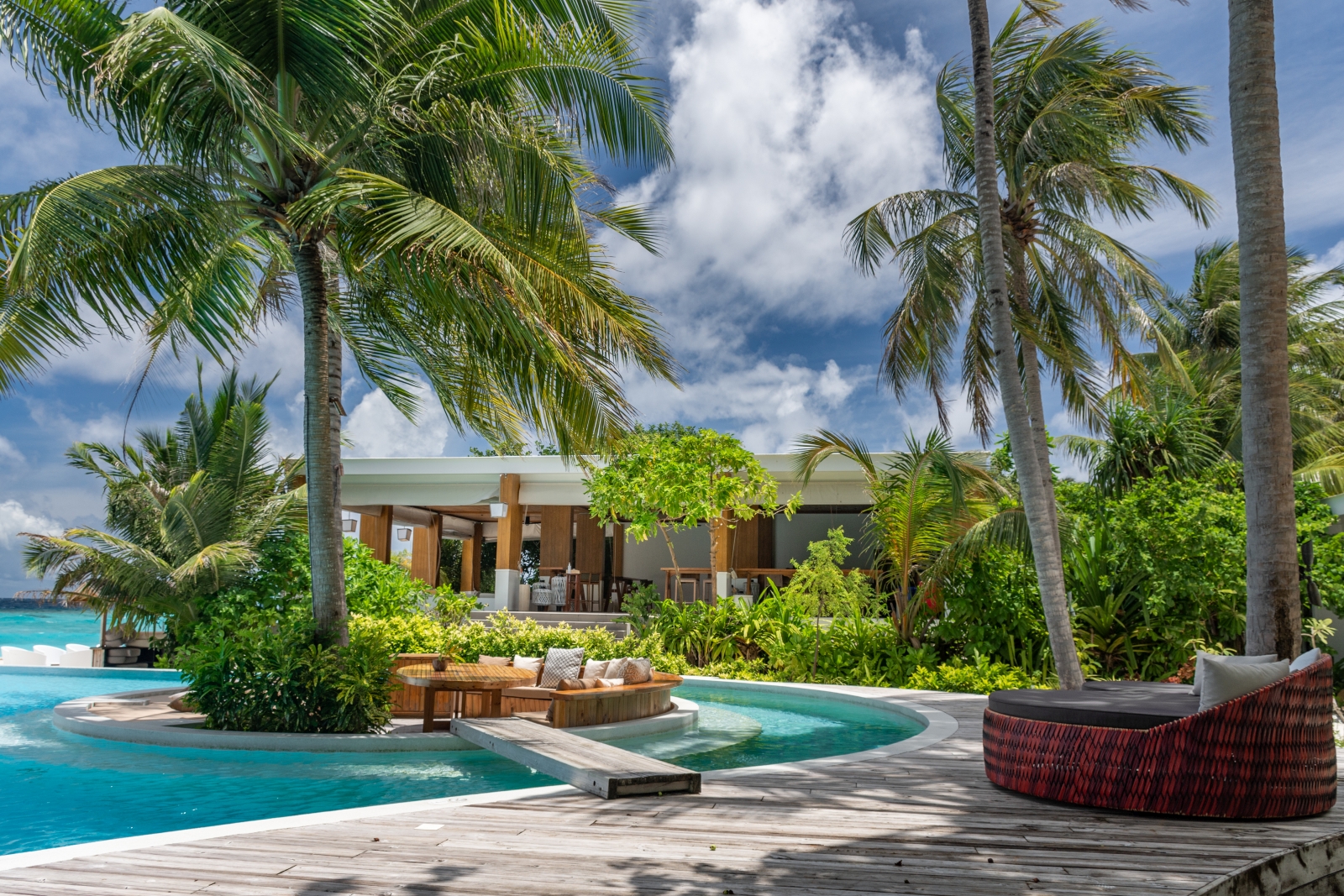 Main pool and loungers at Baa Baa Bar at luxury resort Amilla in the Maldives