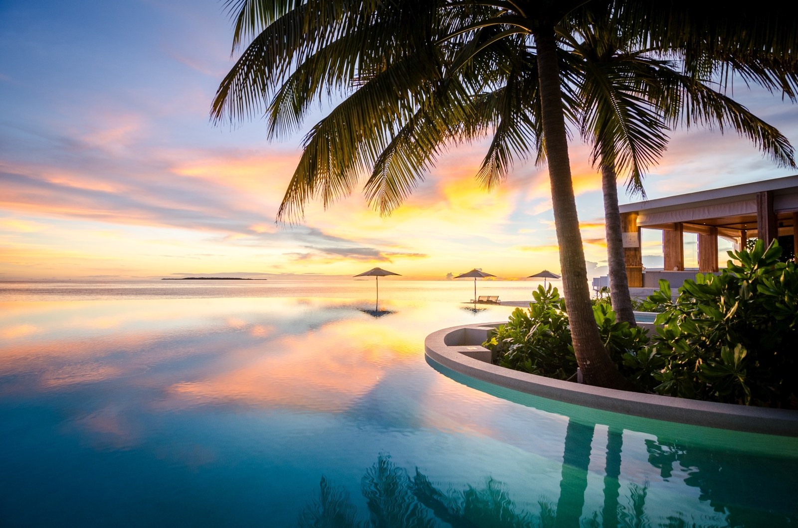 Main pool at sunset at luxury resort Amilla in the Maldives